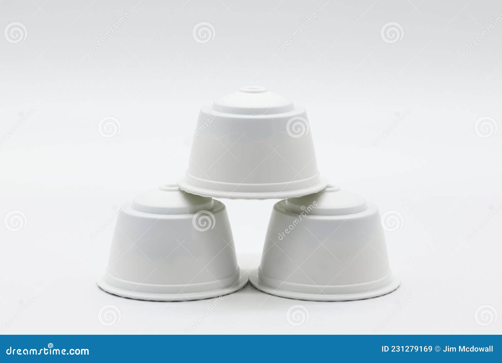 three generic coffee milk pods for coffee machines on a white background