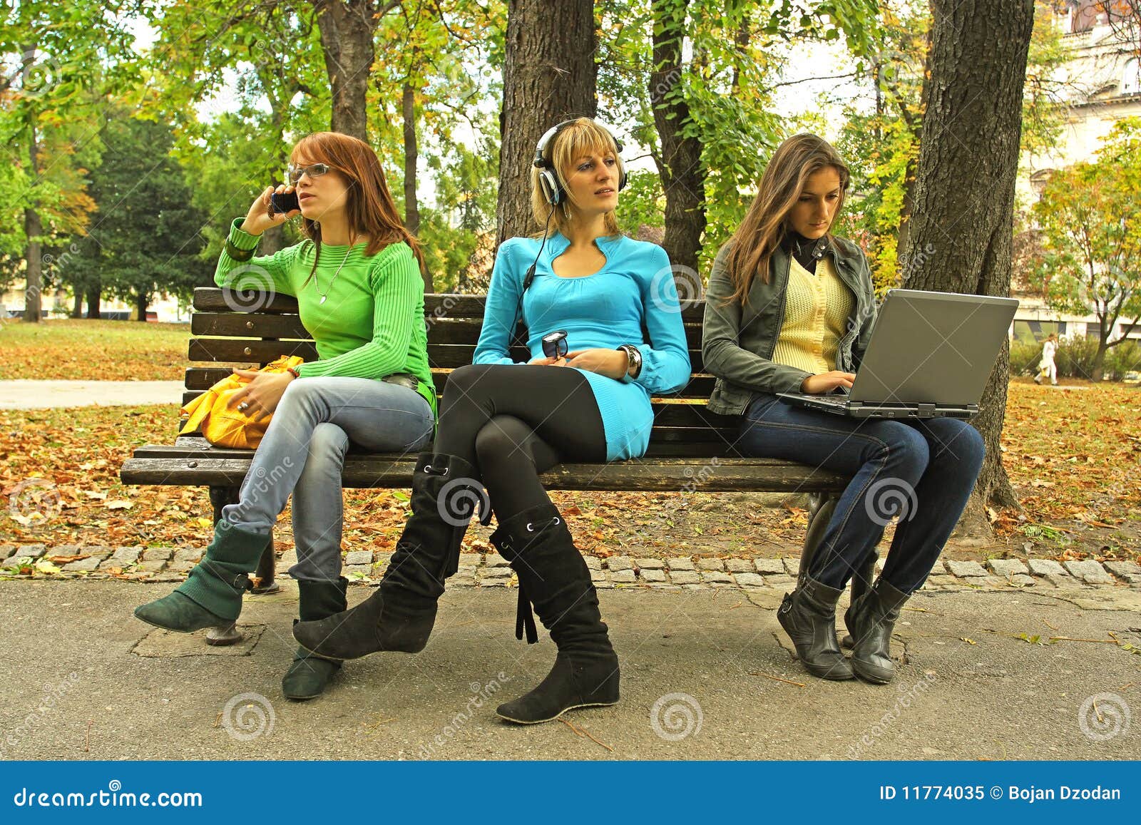 Three girls on a bench stock image. Image of bench, mobile 