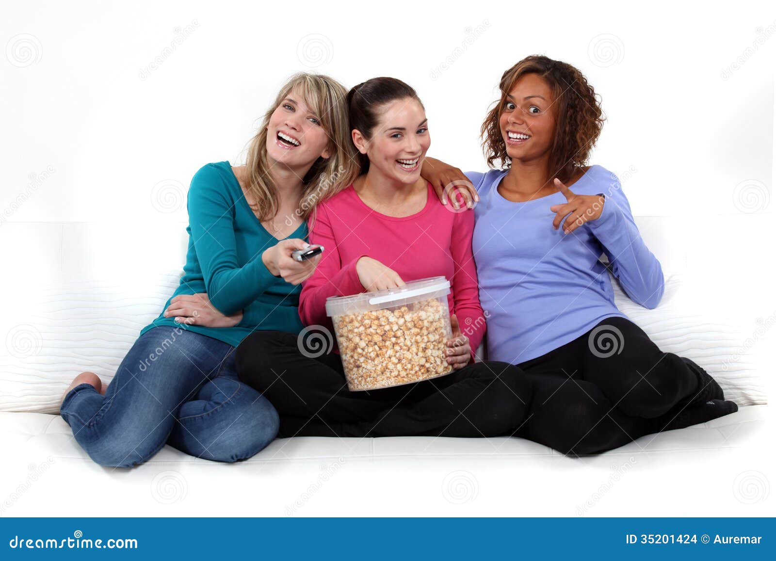 Three girls eating popcorn stock photo. Image of legs 35201424