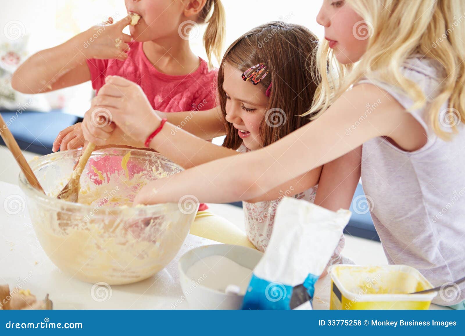 Three Girls Making Cupcakes in Kitchen Stock Ph