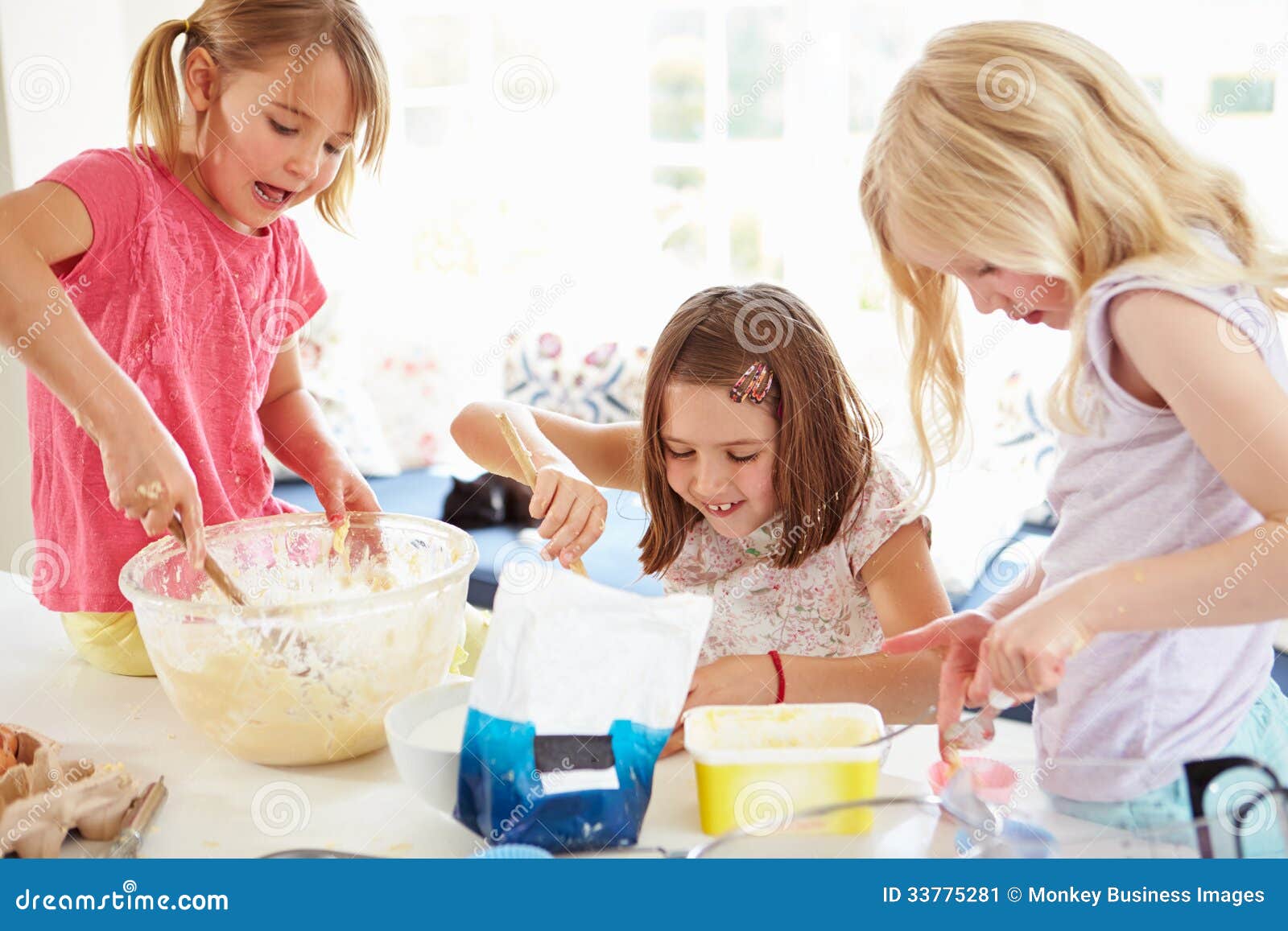 Three Girls Making Cupcakes in Kitchen Stock Im picture image