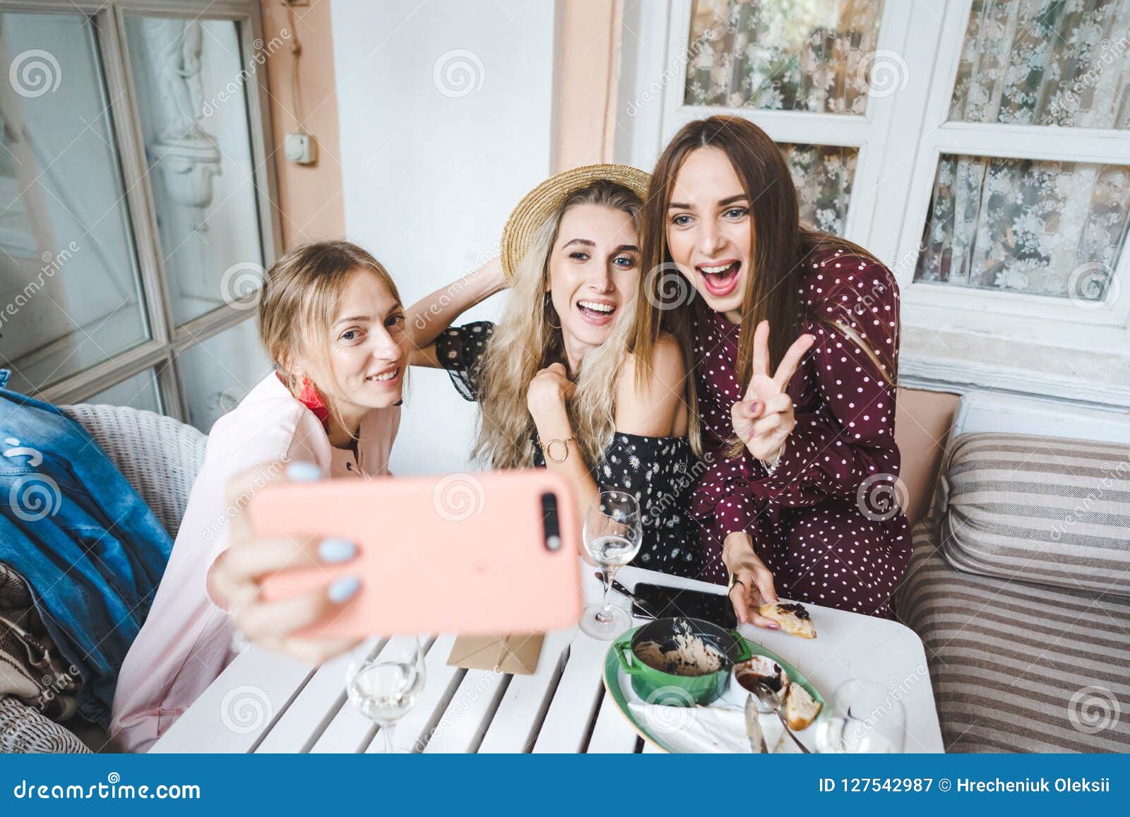 Three girls at the table stock image. Image of camera - 127542987