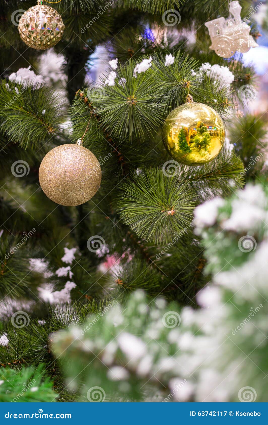 Three Golden Christmas Baubles on a Tree Brunch Stock Image - Image of ...