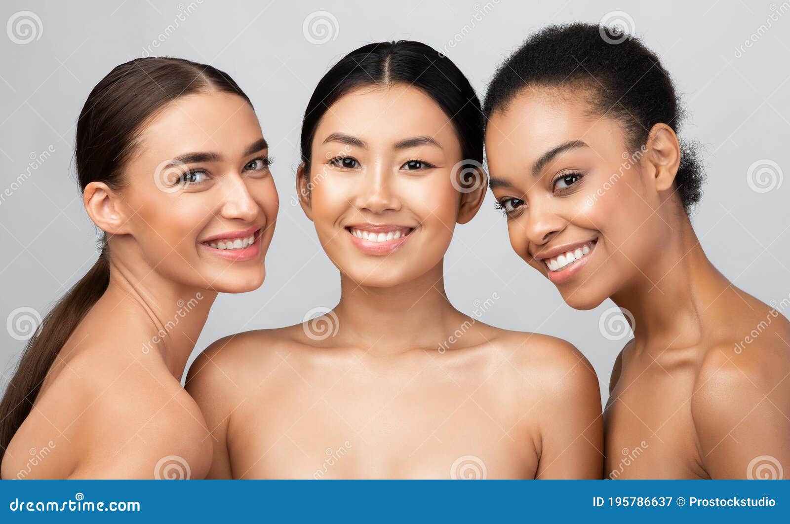 three gorgeous girls models posing naked standing over gray background