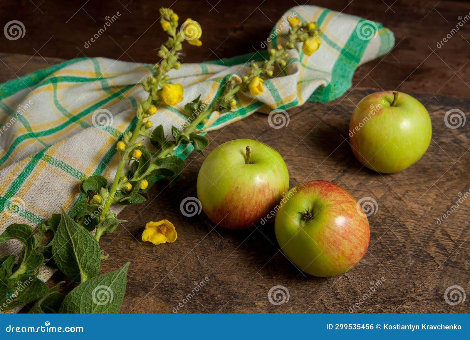 Three Green Apples on Wooden Background with Green Kitchen Towel Stock
