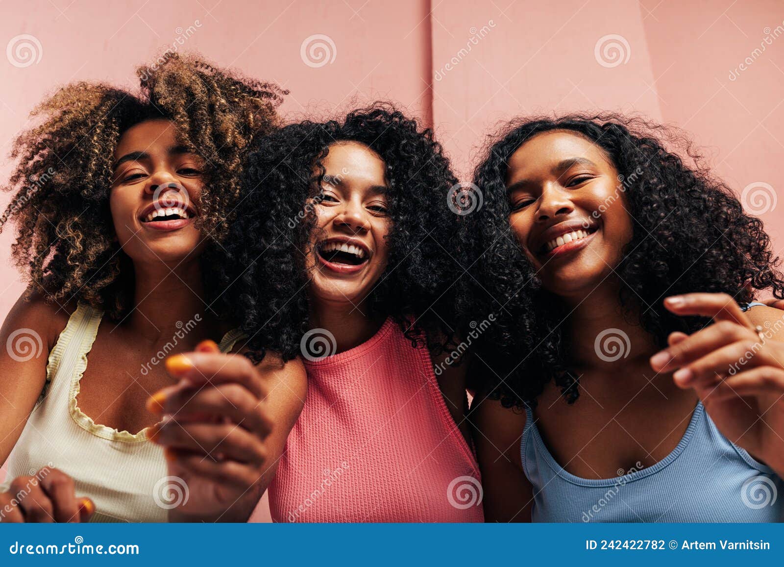 Three Happy Girlfriends with Curly Hair Laughing Together and Looking ...