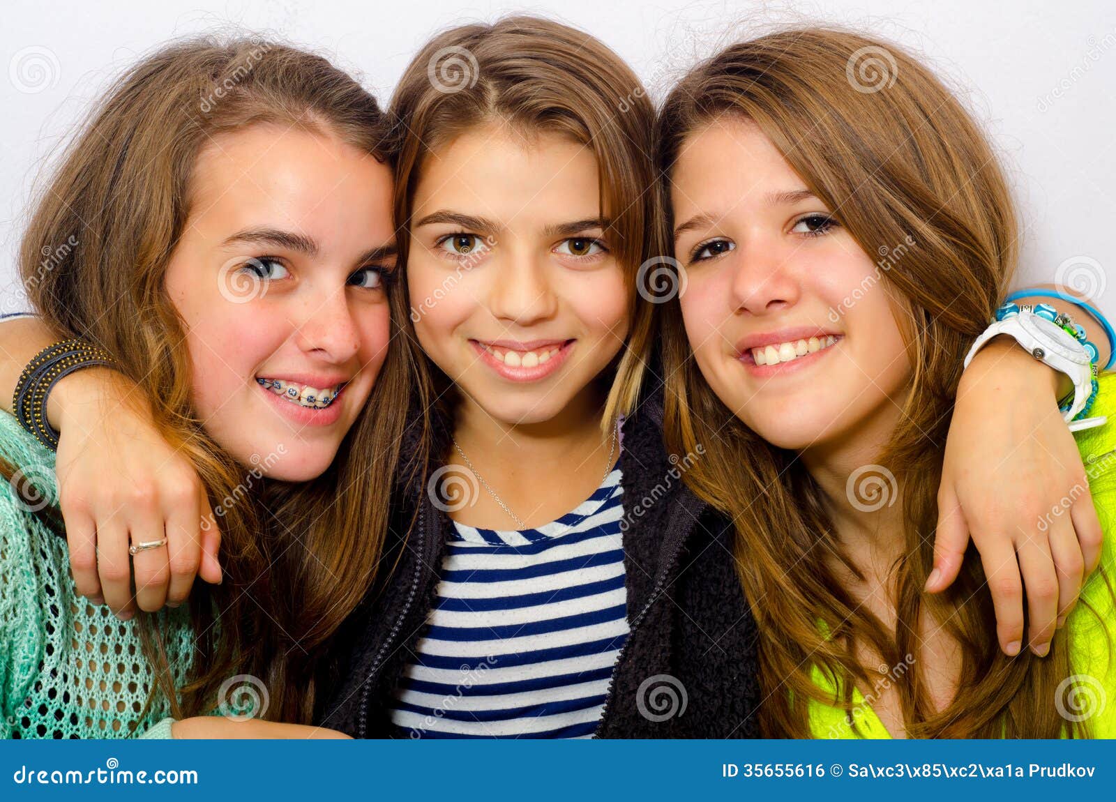 Three Happy Girls Toasting Beers Laying Down At The Beach Outdoors In