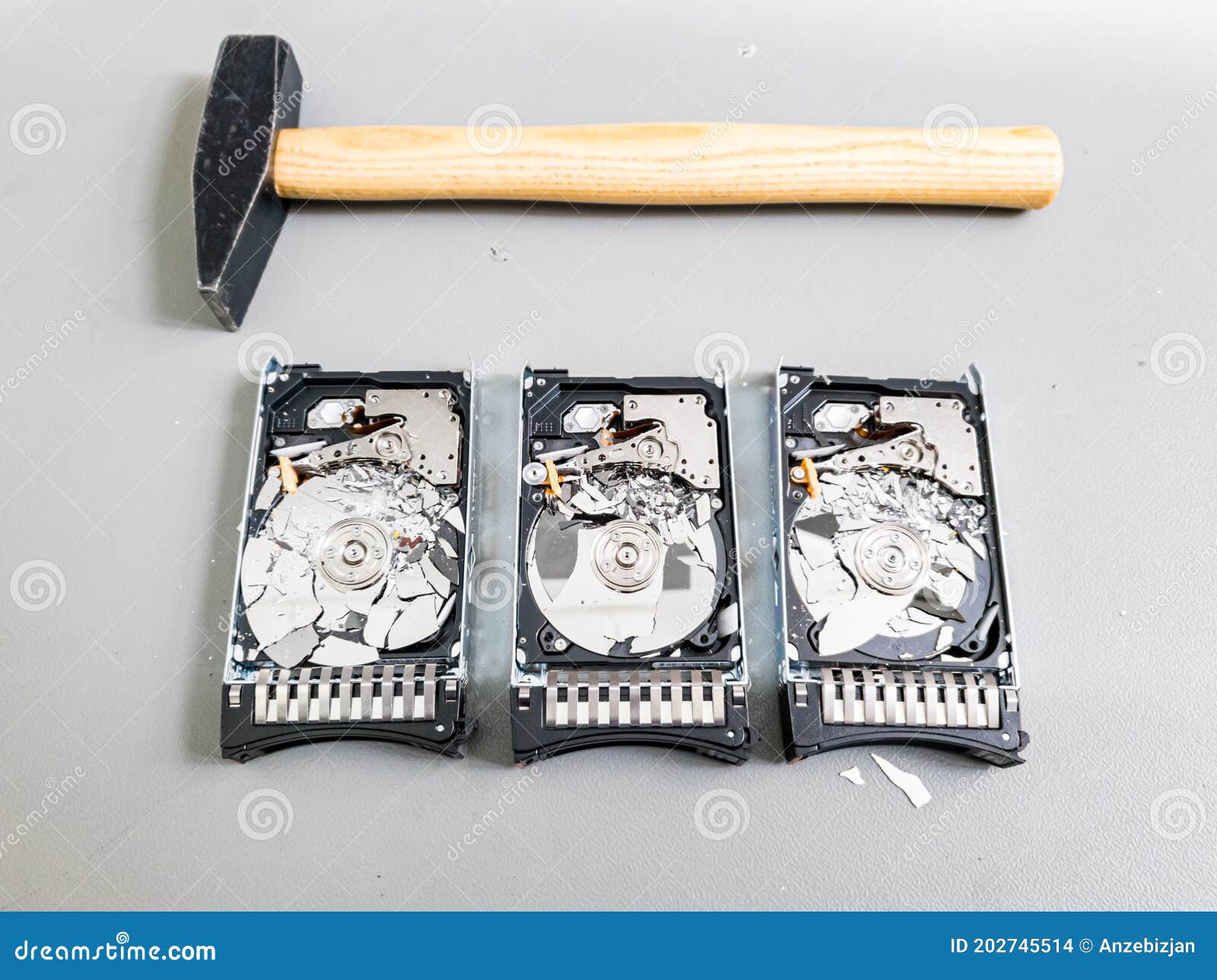 Three Hard Disk Drives with Shattered Platter on a Table. Stock Photo