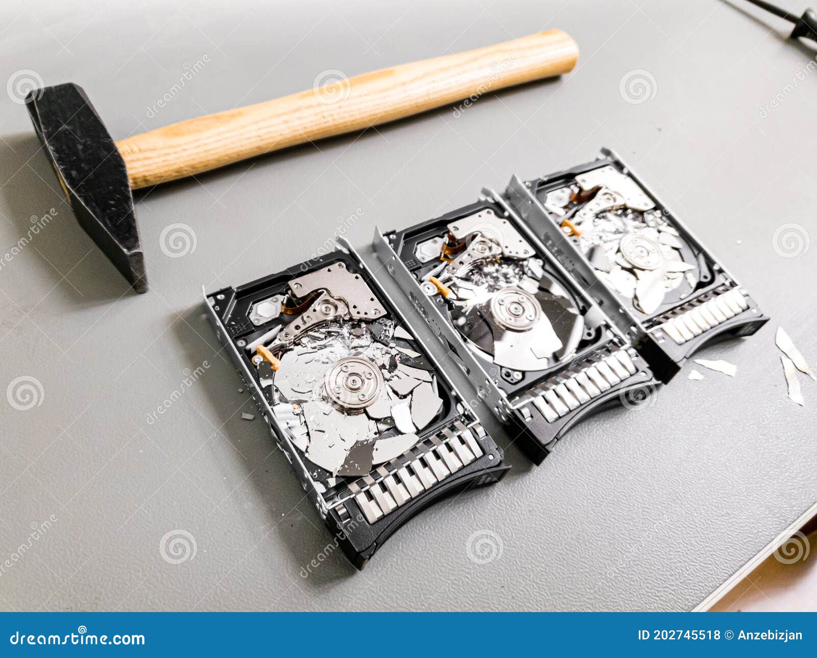 Three Hard Disk Drives with Shattered Platter on a Table. Stock Photo