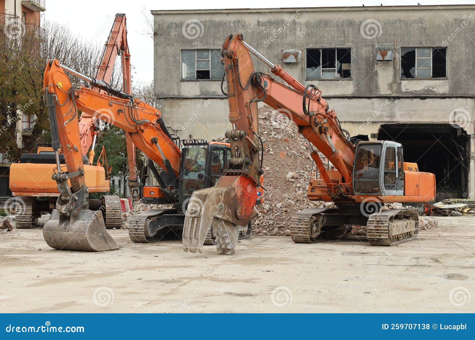 Three Heavy Excavators during a Redevelopment Work of Urban Area. Stock