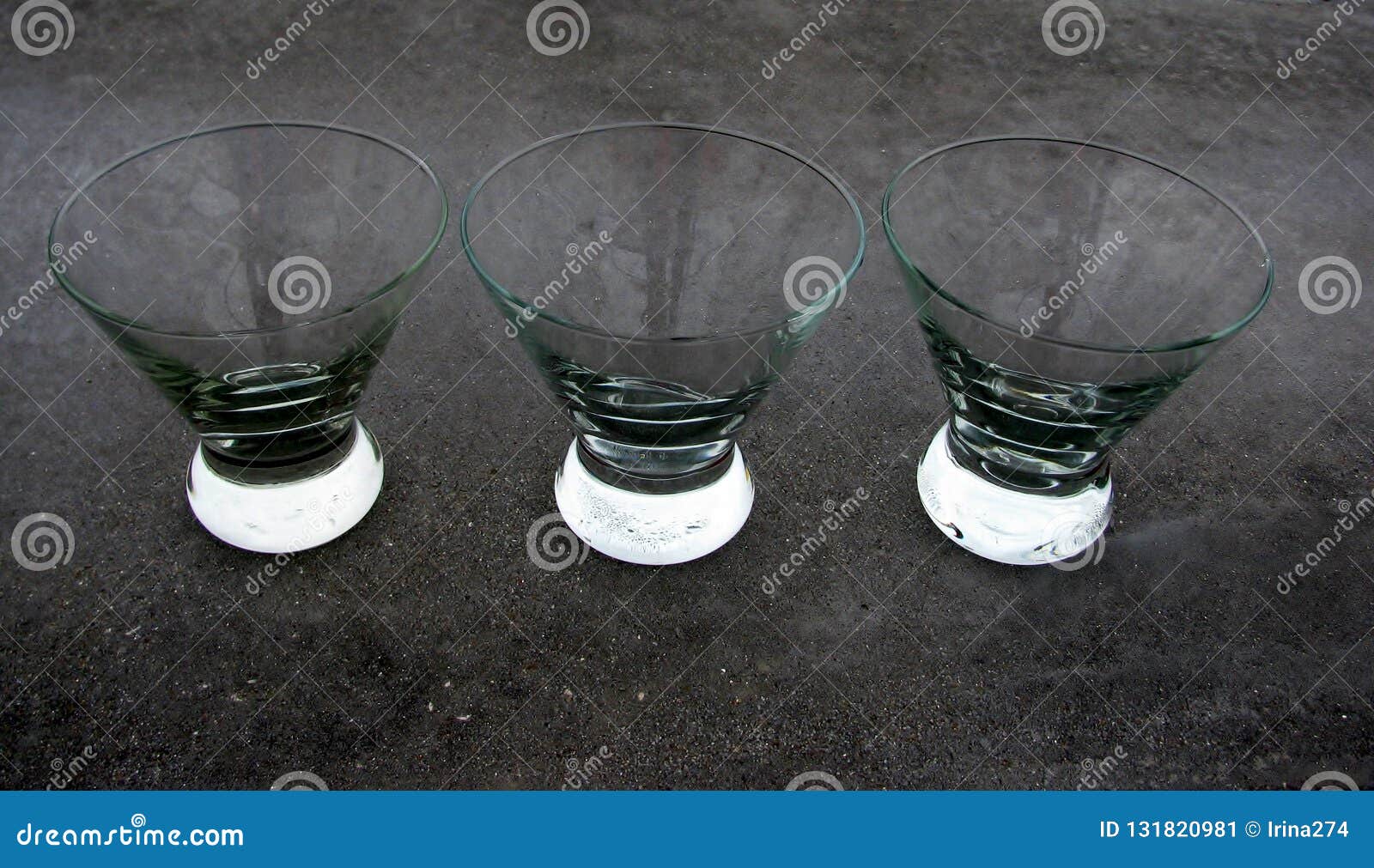 Three Inverted Cone Bowl Glasses On A Concrete Countertopgrey