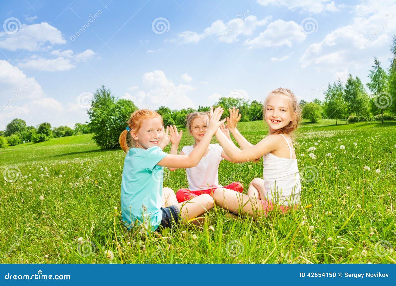 Three Kids Playing on a Grass Stock Photo - Image of group, grass: 42654150