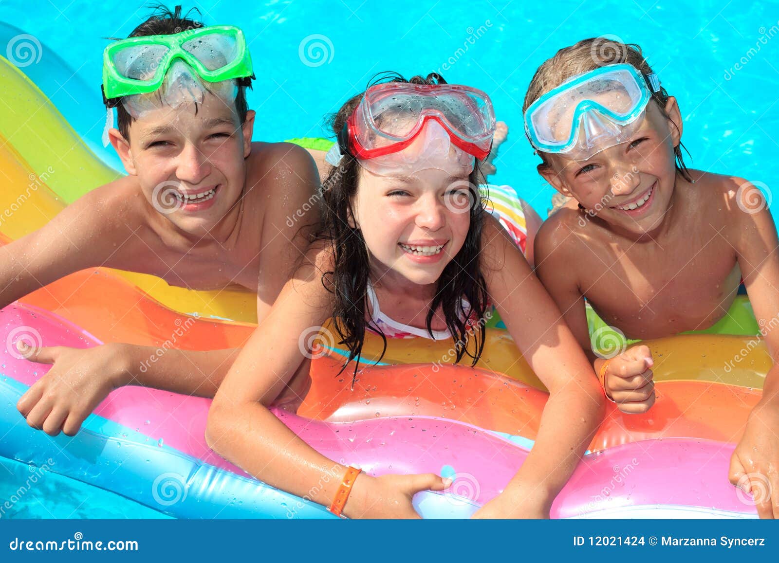 Three kids in the pool. Three happy kids in a swimming pool.