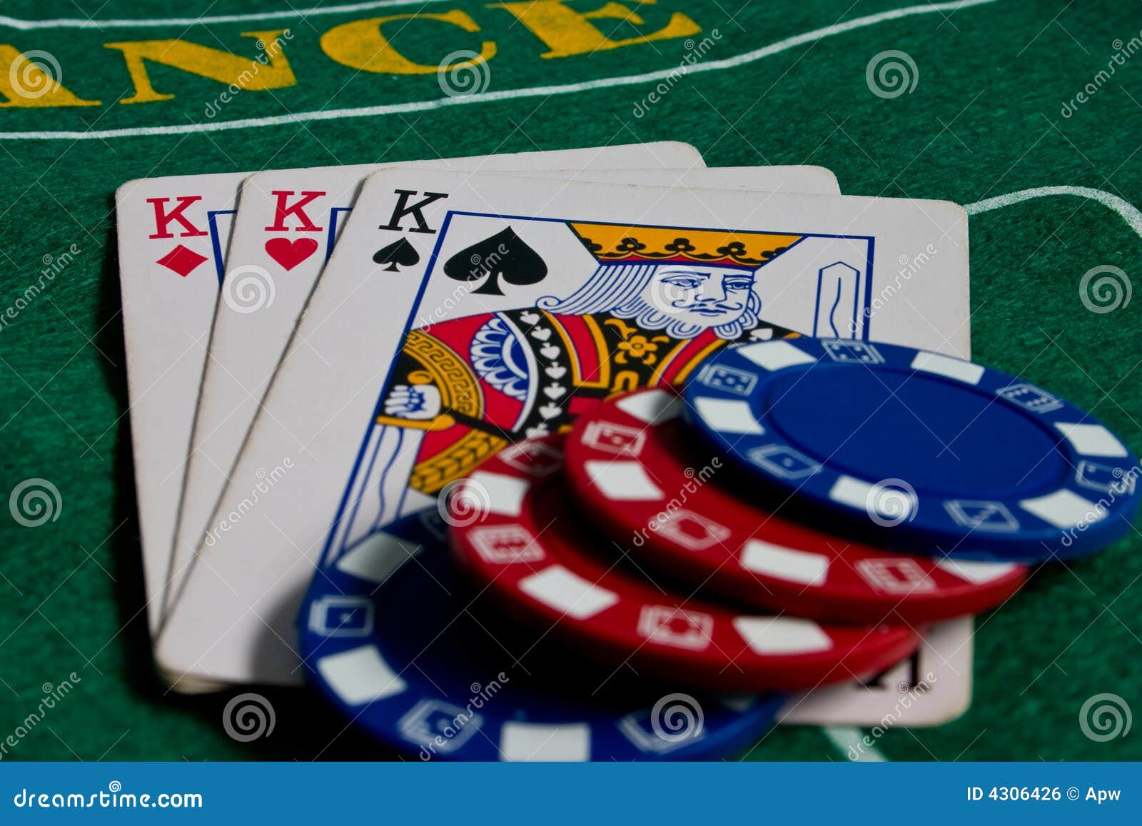 A set of three playing cards showing a Jack, Queen and King. All