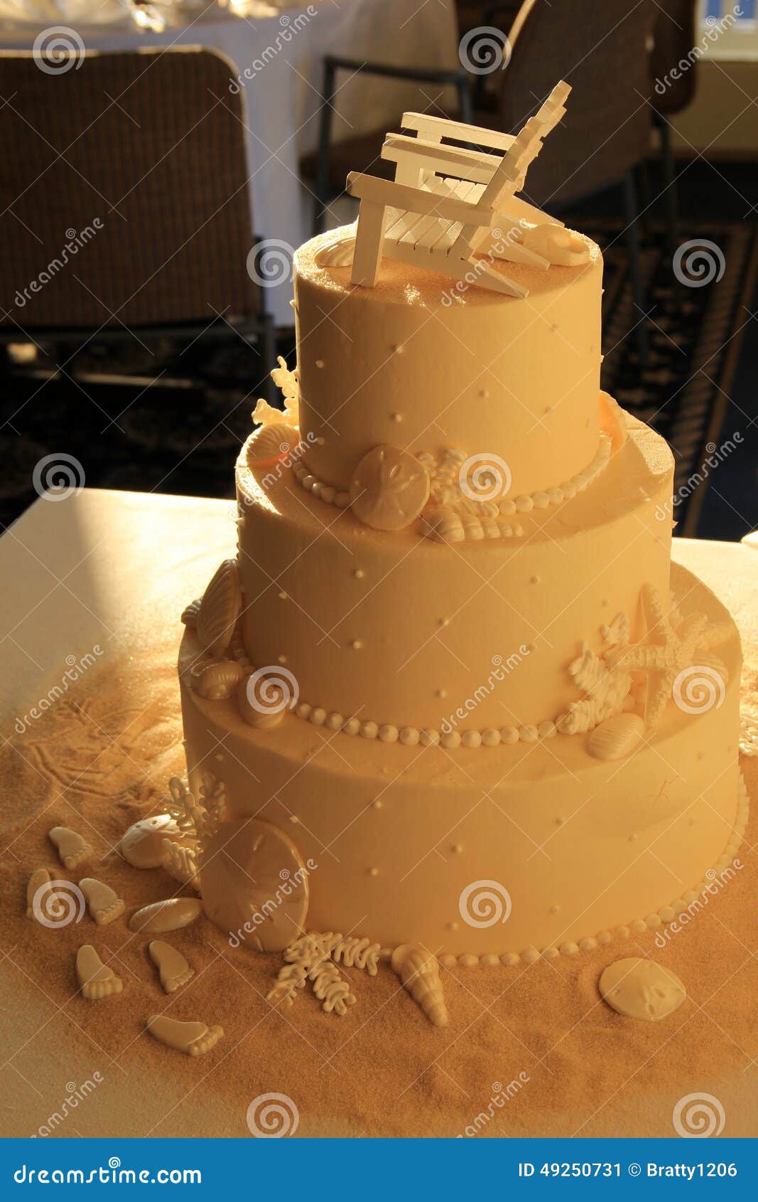 Three Layered Wedding Cake With Beach Theme On Table Stock Image