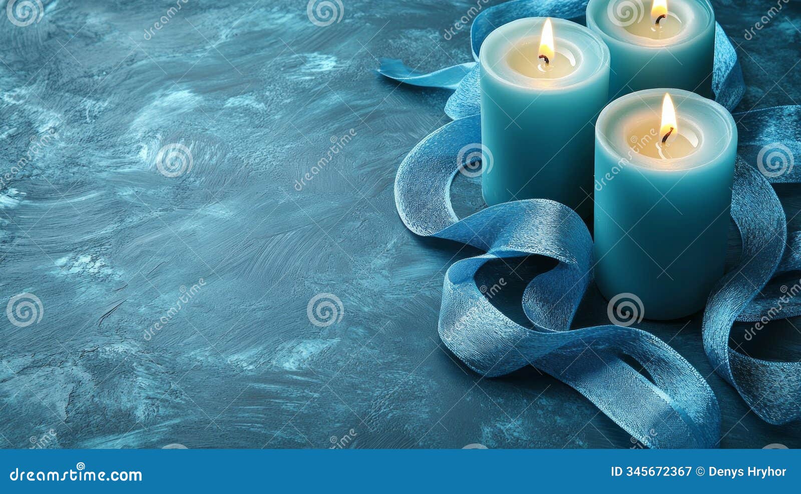three lit blue candles accompanied by a silky ribbon rest on a textured surface, inspiring tranquility and warmth in a