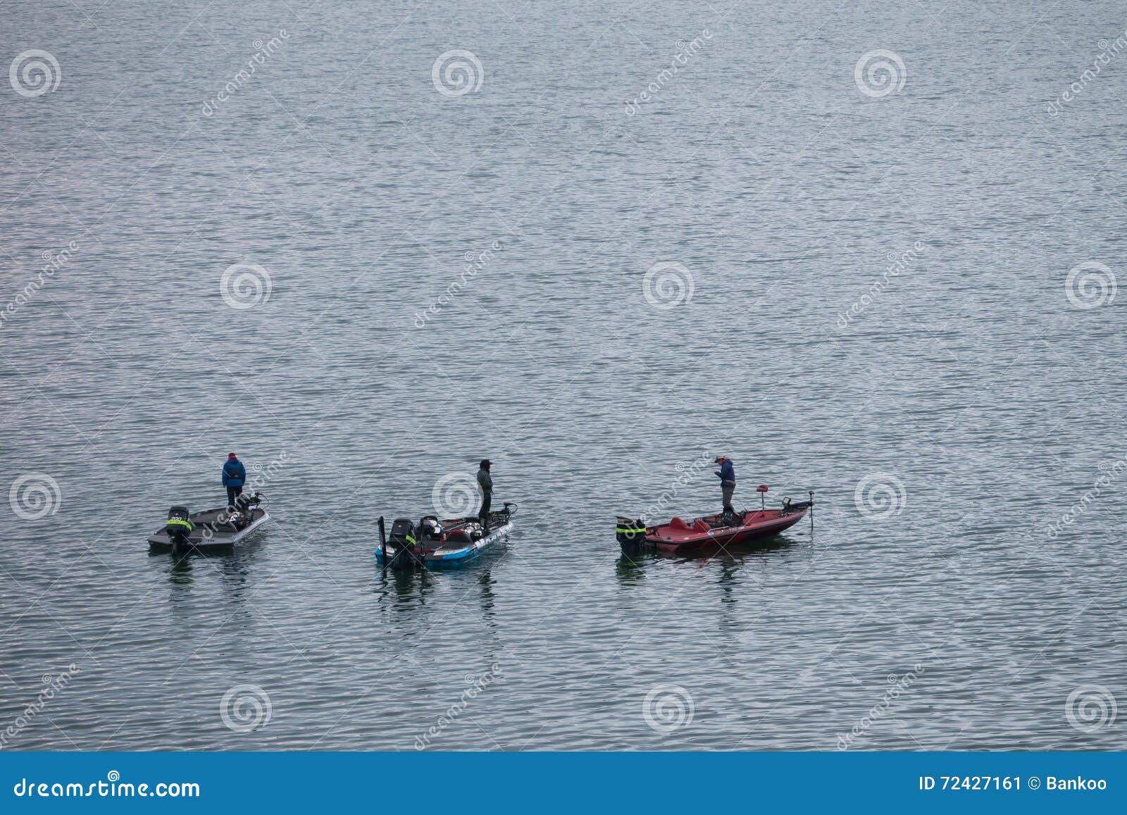 English: Two men and boy fishing in unidentified river with poles