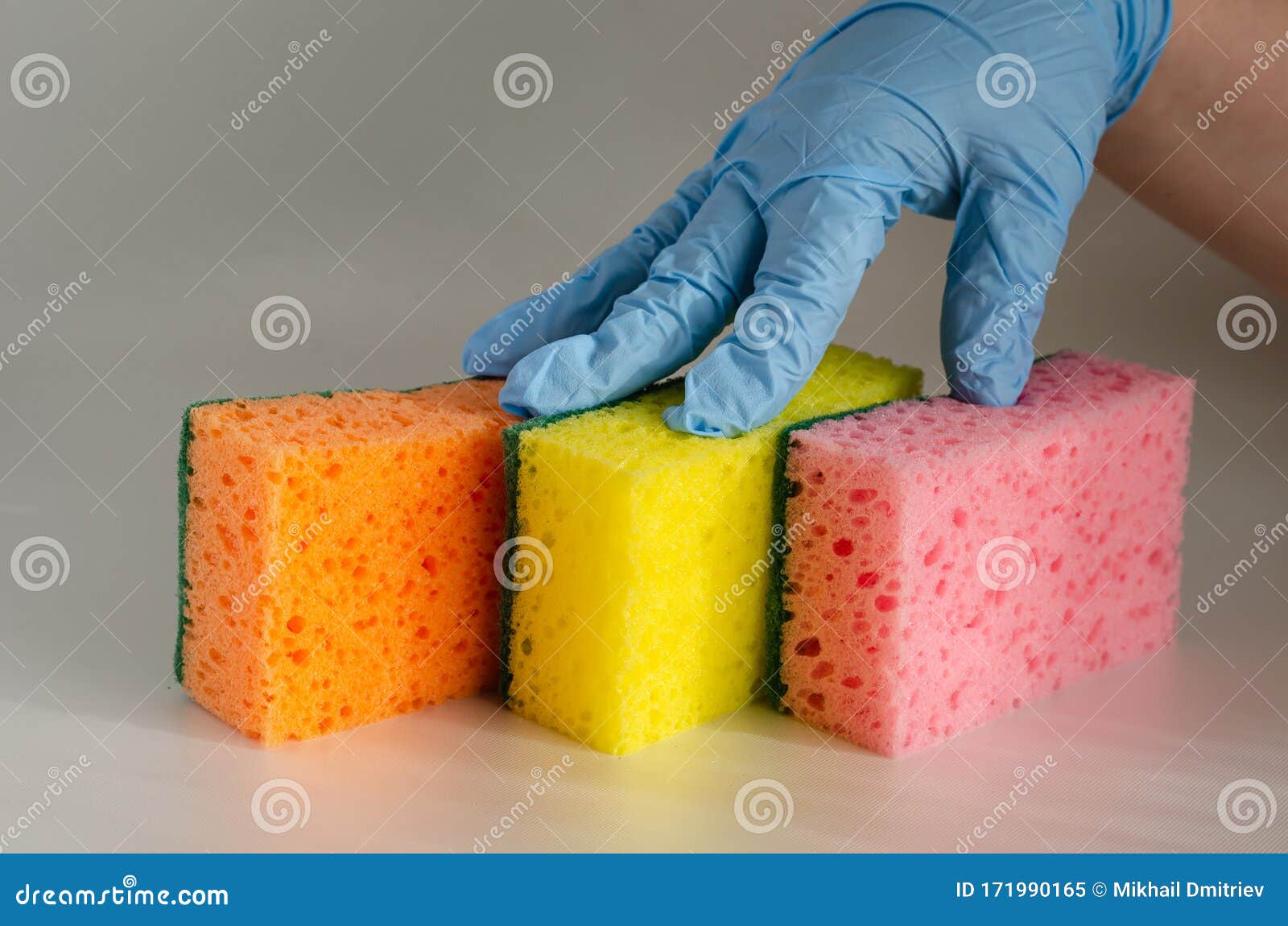 https://thumbs.dreamstime.com/z/three-multi-colored-kitchen-sponges-table-fingers-protective-glove-press-new-to-commercial-cleaning-company-home-171990165.jpg