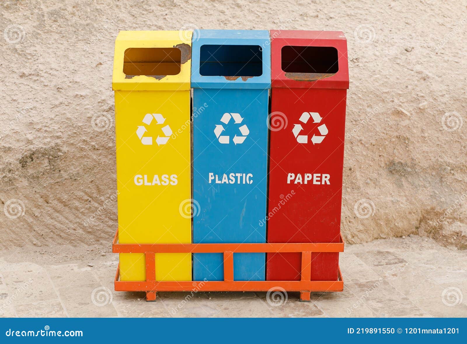 Three Multicolored Waste Bins, With Signs Of Old Age And Rust, For