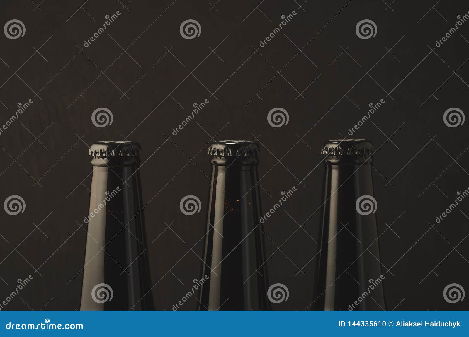 Three Necks with a Stopper of Beer Bottles/three Necks with a Stopper of Beer Bottles on a Dark