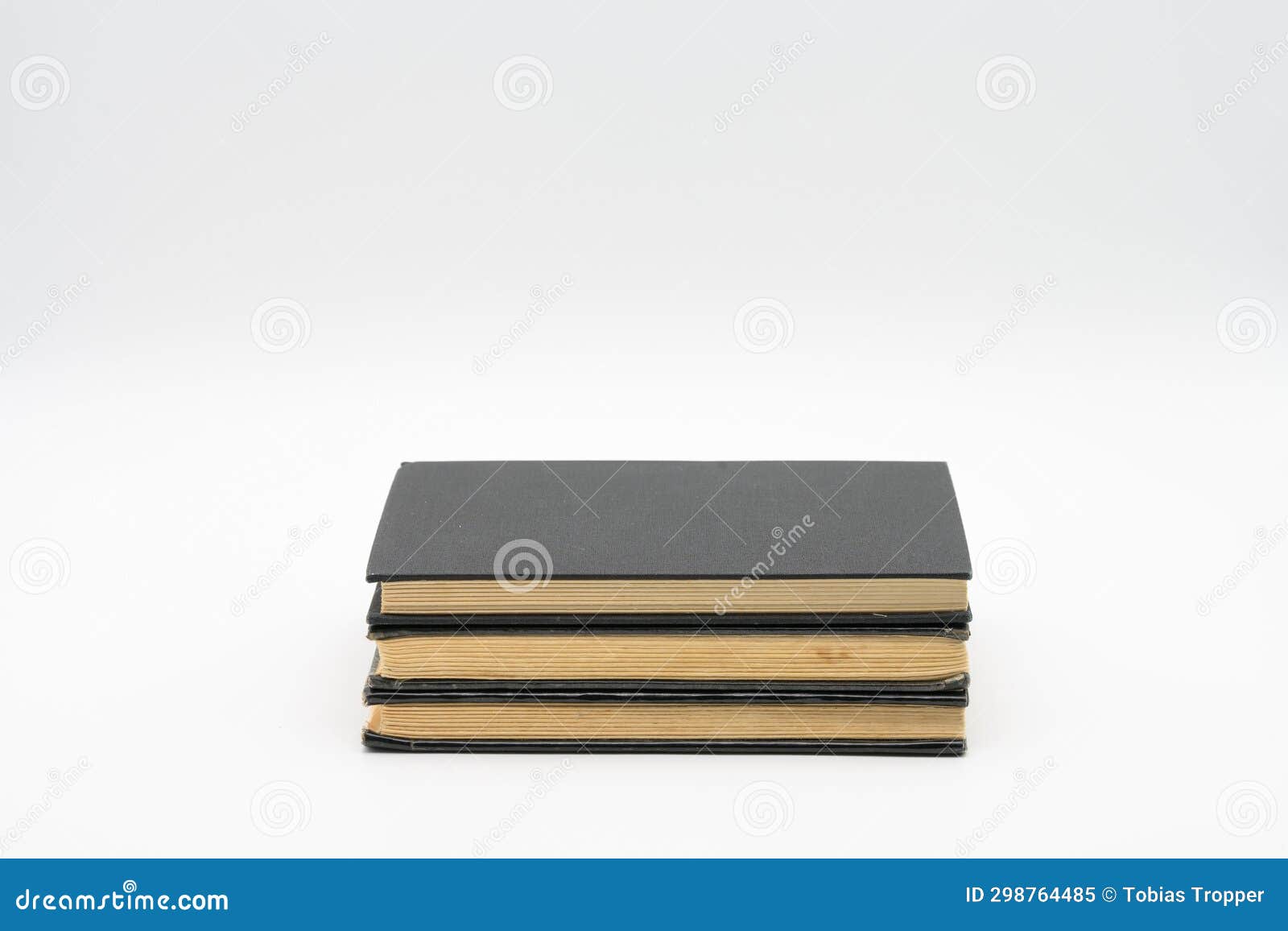 Three Old Books with Black Covers Isolated on Top of Each Other on a ...