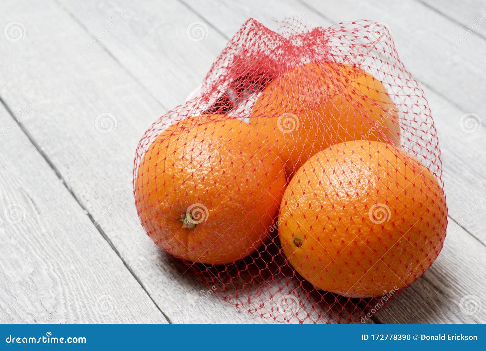 Three Oranges in Net Bag stock photo. Image of texture 172778390
