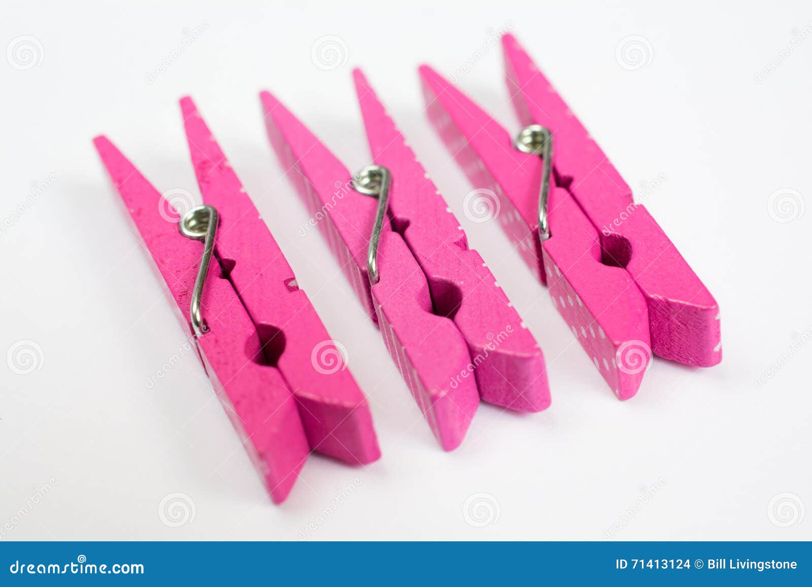 Three Pink Clothes Pins with Fun Patterns on Sides Perspective V Stock