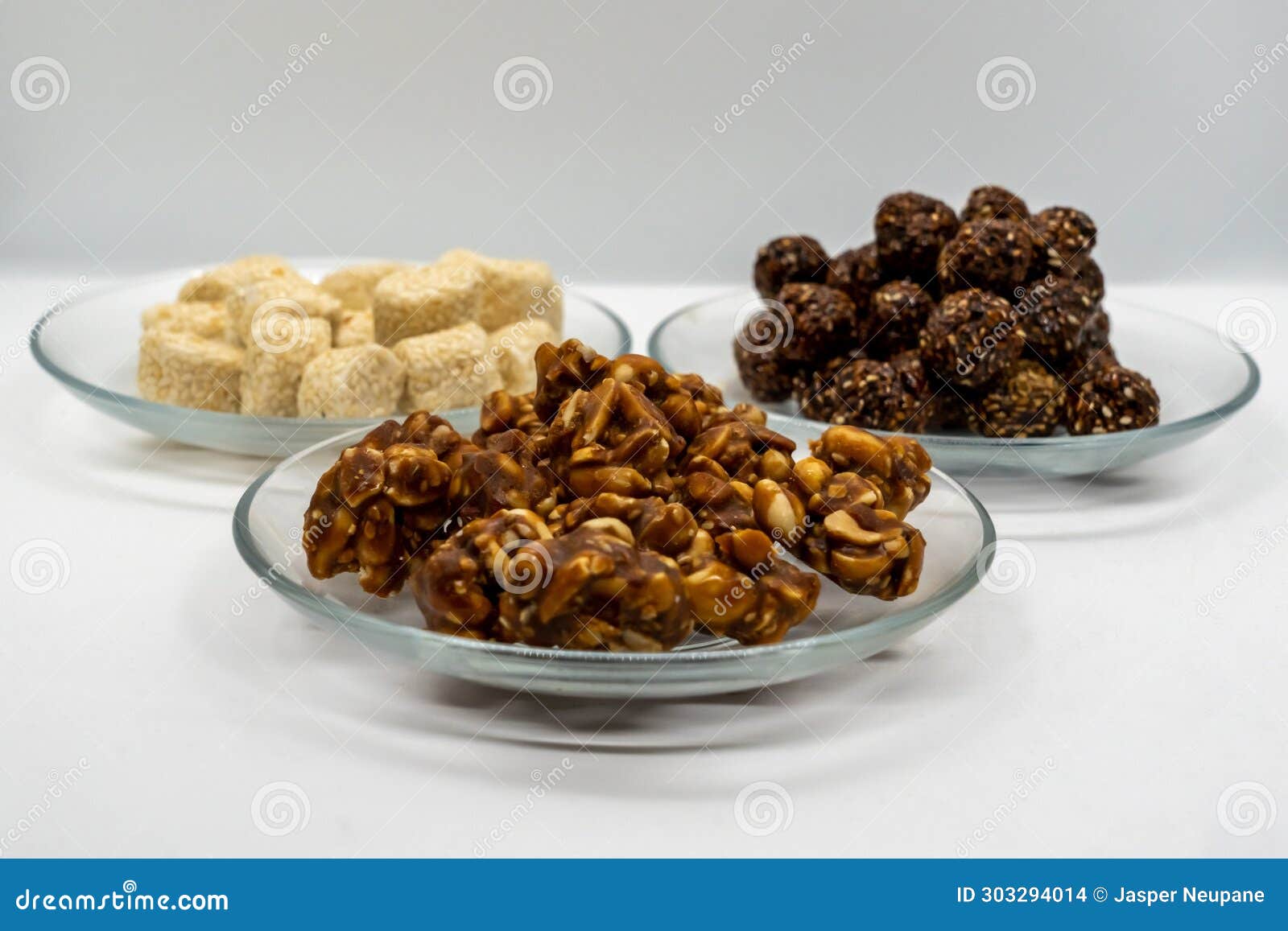 three plates full of sesame ladoo, til ko laddu, jaggery peanuts laddoo for maghe sankranti and makar sankranti festival