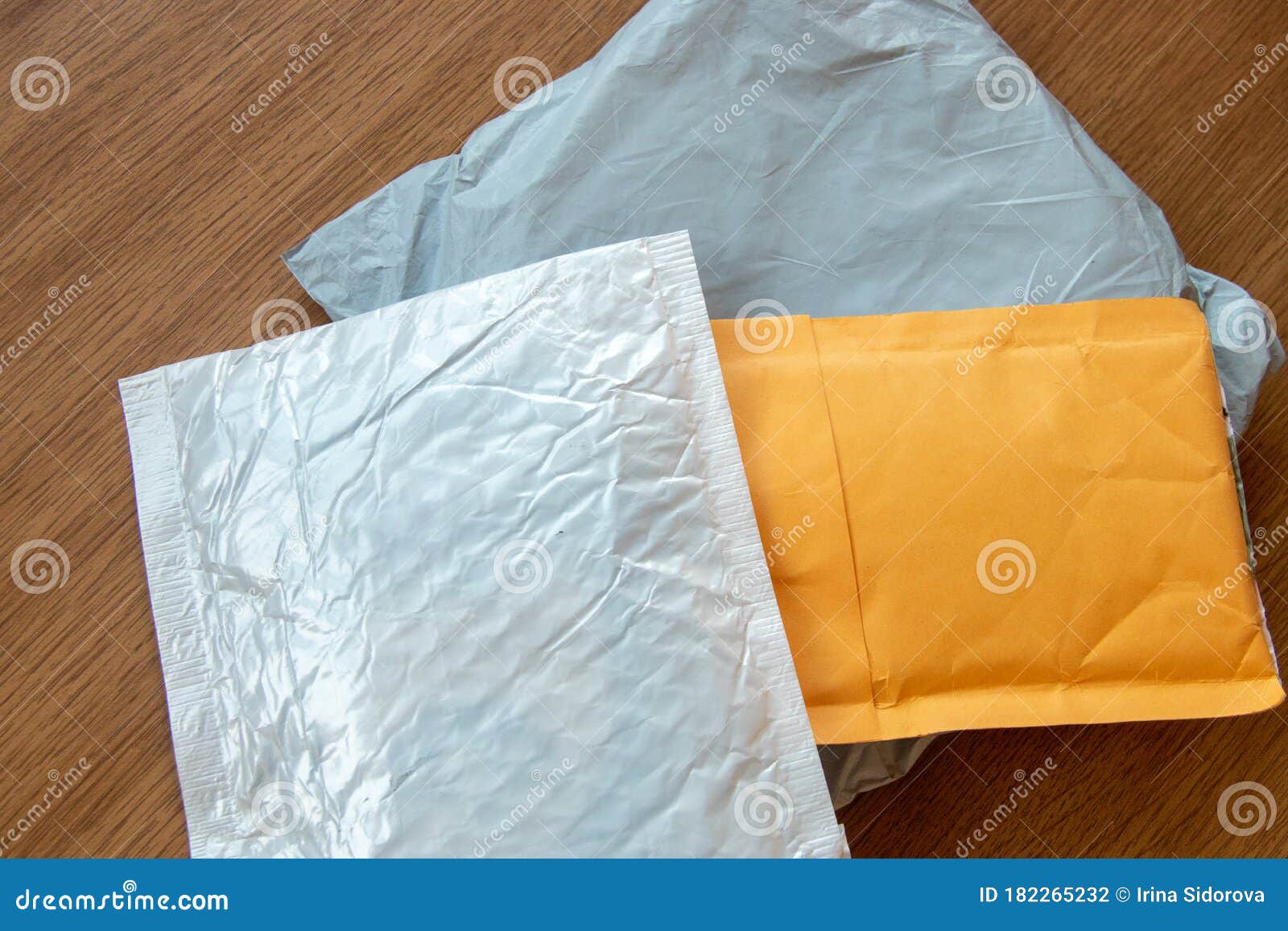 Three Postal Parcels Small Package White, Gray and Yellow on Wooden