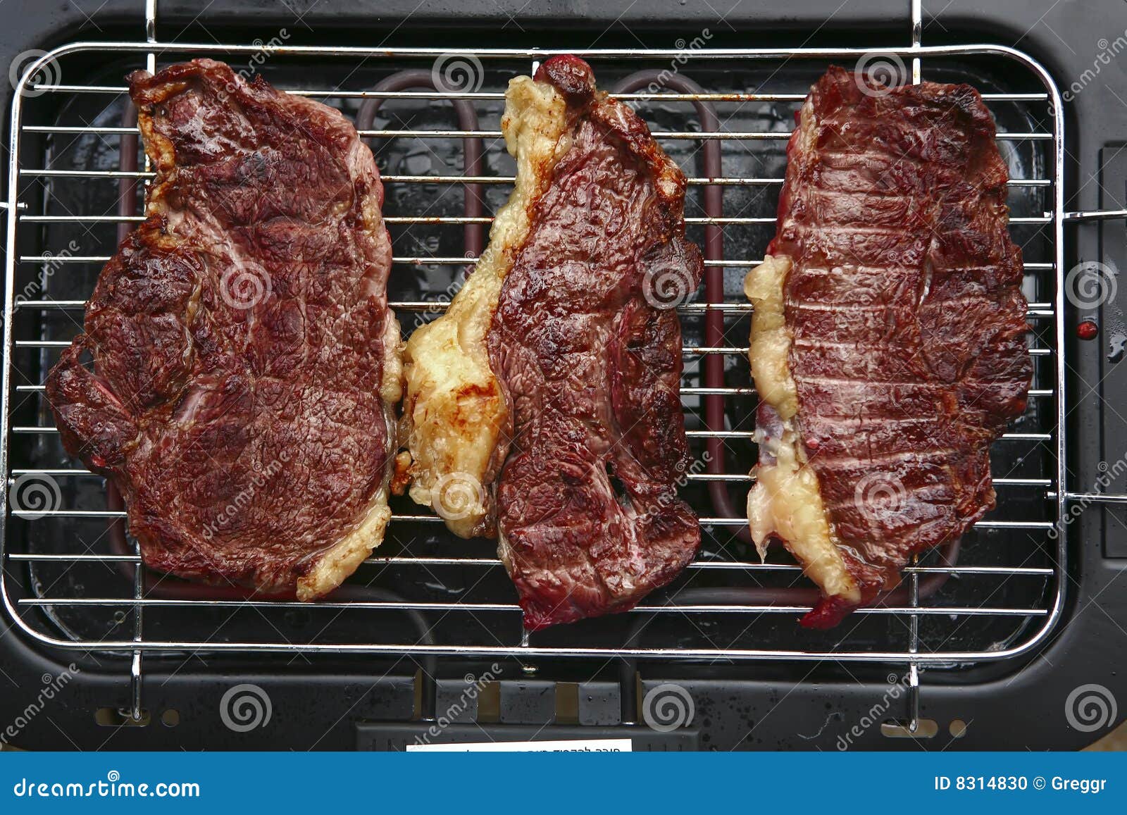 three roast steak on electrical brazier