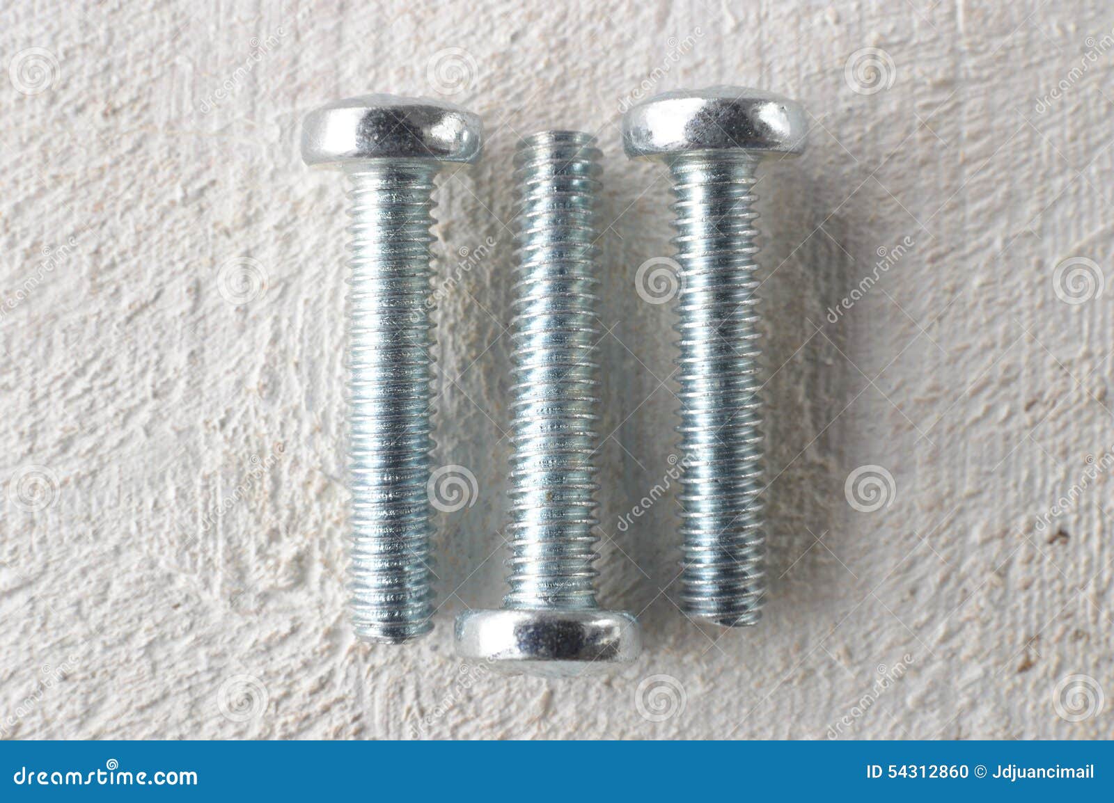 Three Screws on a White Wooden Table Stock Photo Image of table