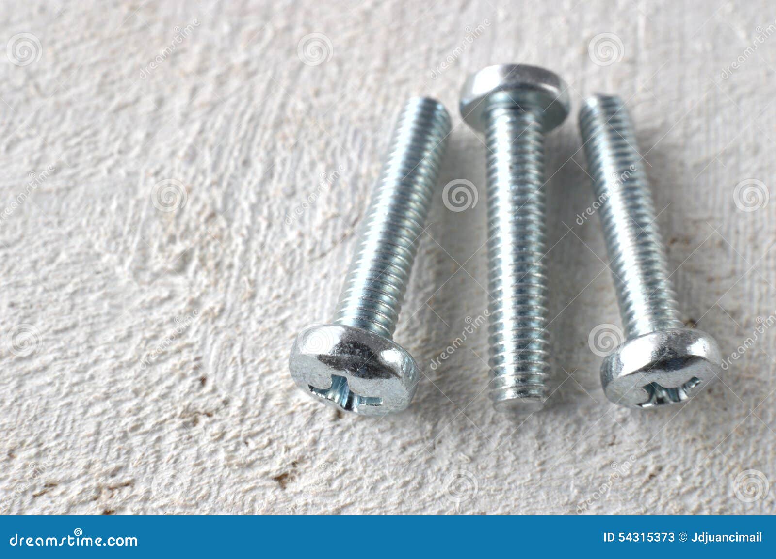 Three Screws on a White Wooden Table Stock Image Image of object