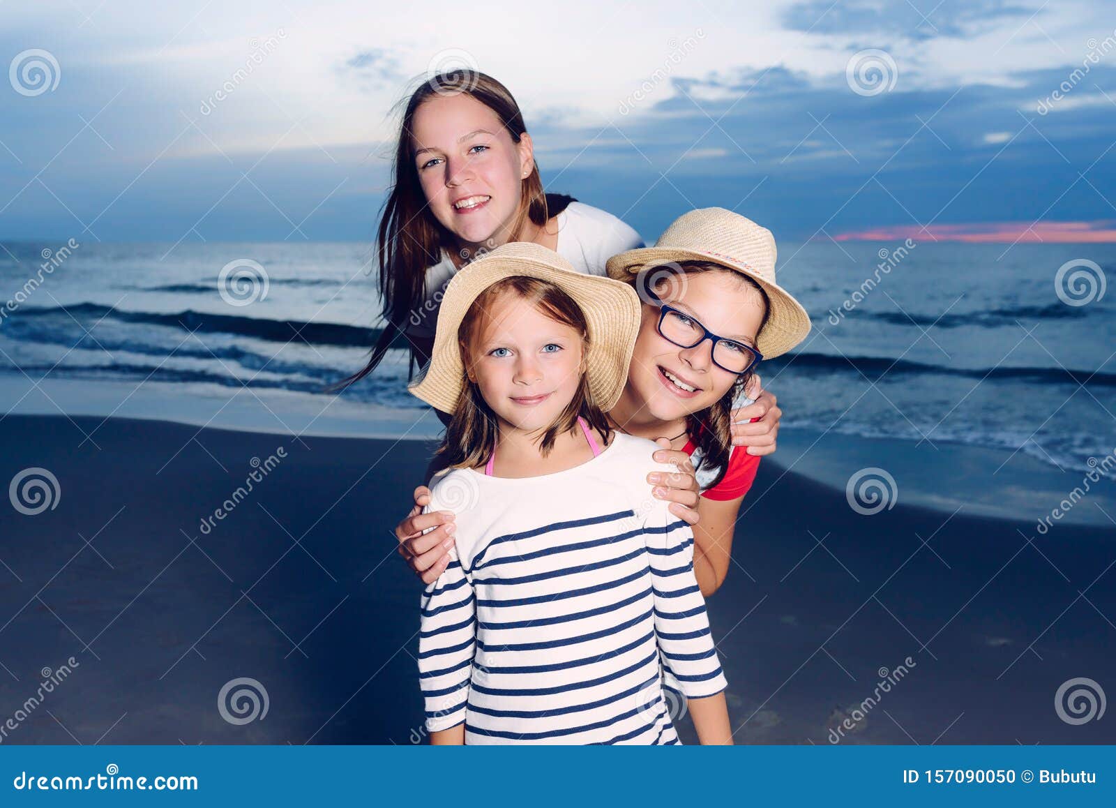 Three Sisters Having Fun on Beach, Friends on Beach in Dusk Time Stock