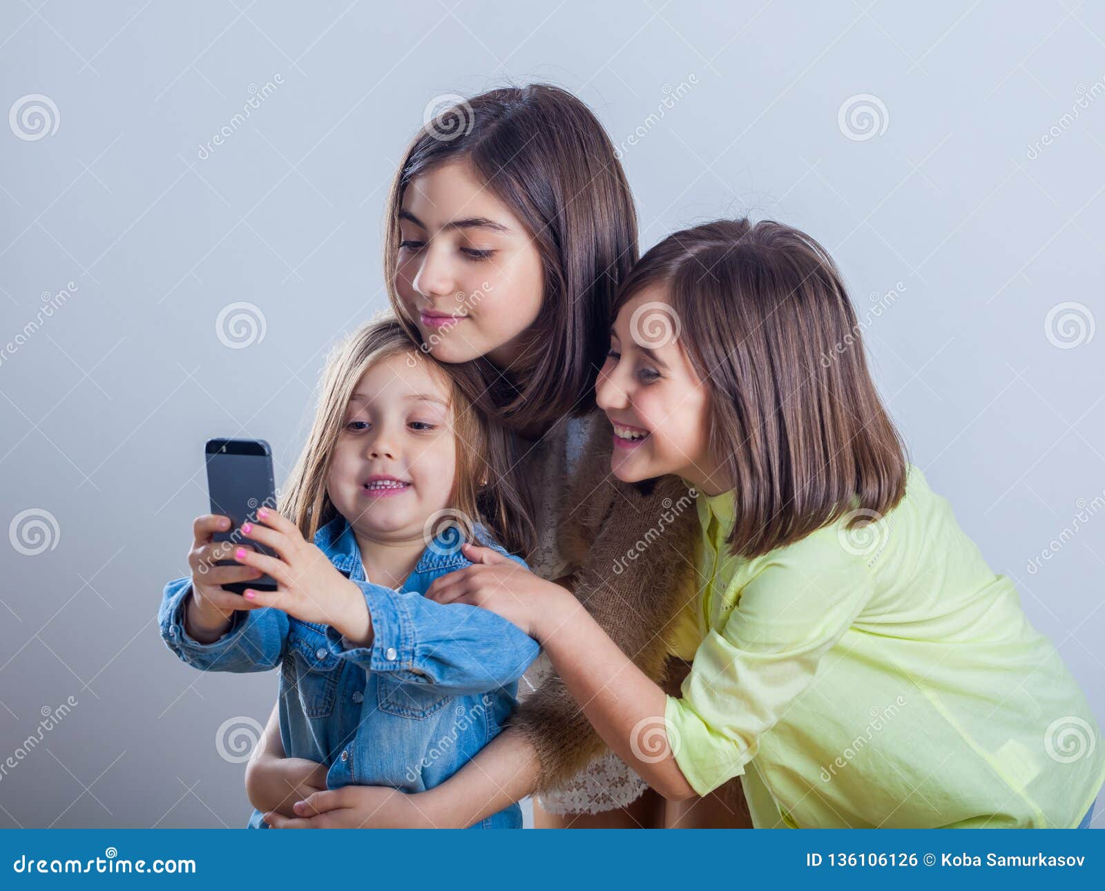 Three Sisters Posing and Taking Selfies in the Studio Stock Photo ...