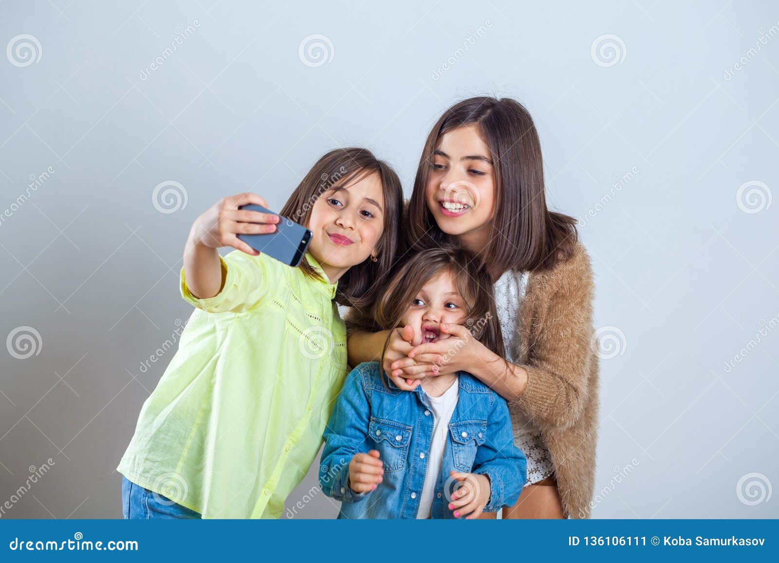 Three Sisters Posing and Taking Selfies in the Studio Stock Image ...