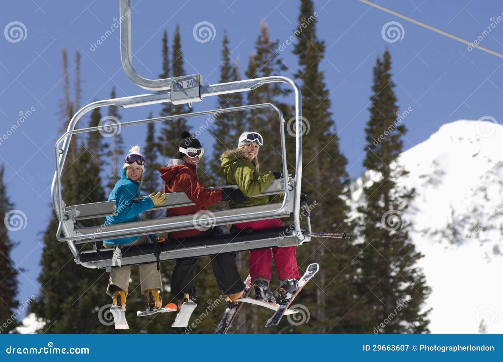 Three Skiers on Chair Lift stock image. Image of chairlift 29663607