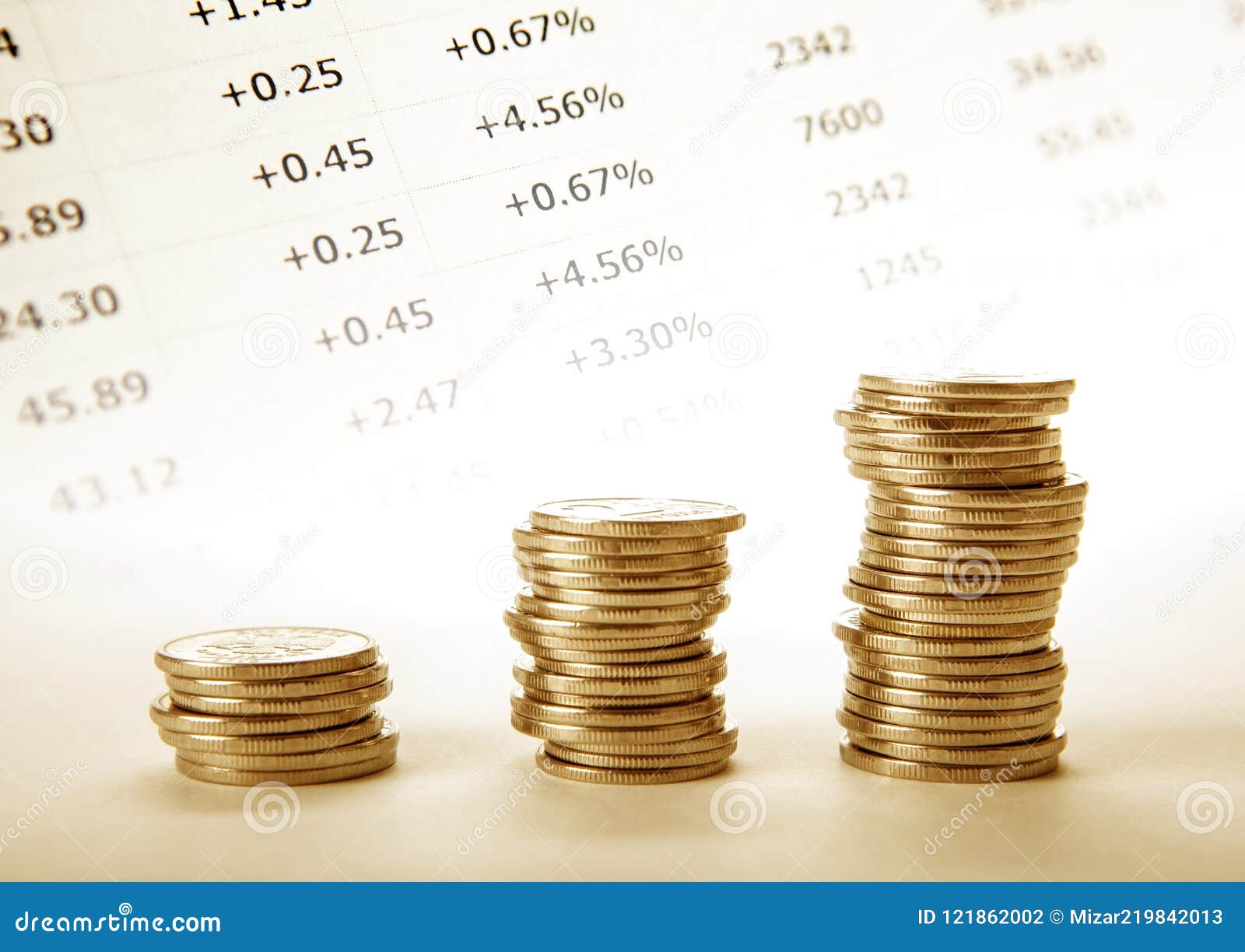 three stacks of golden coins with accounting digits