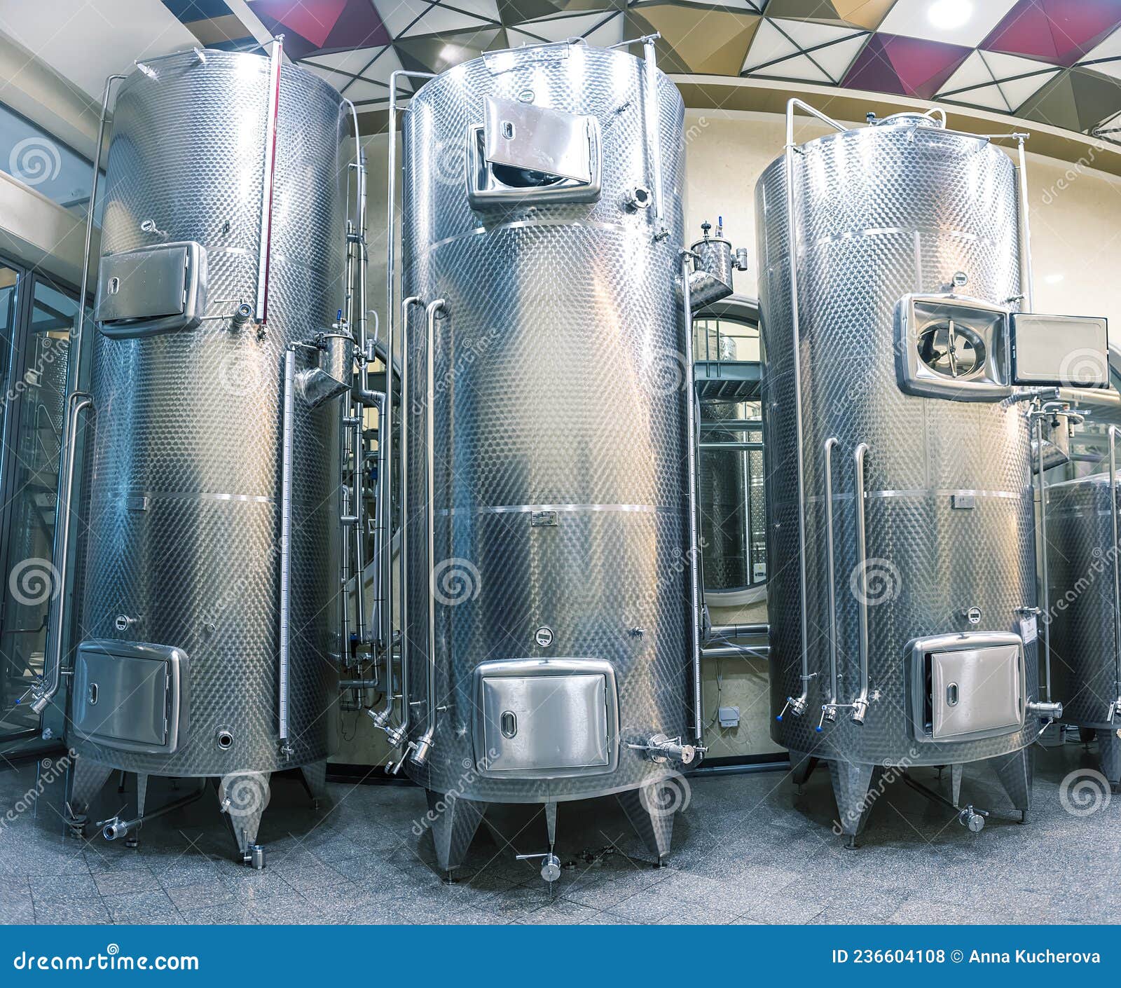 Three Stainless Steel Wine Tanks in a Row in Winery Stock Photo Image