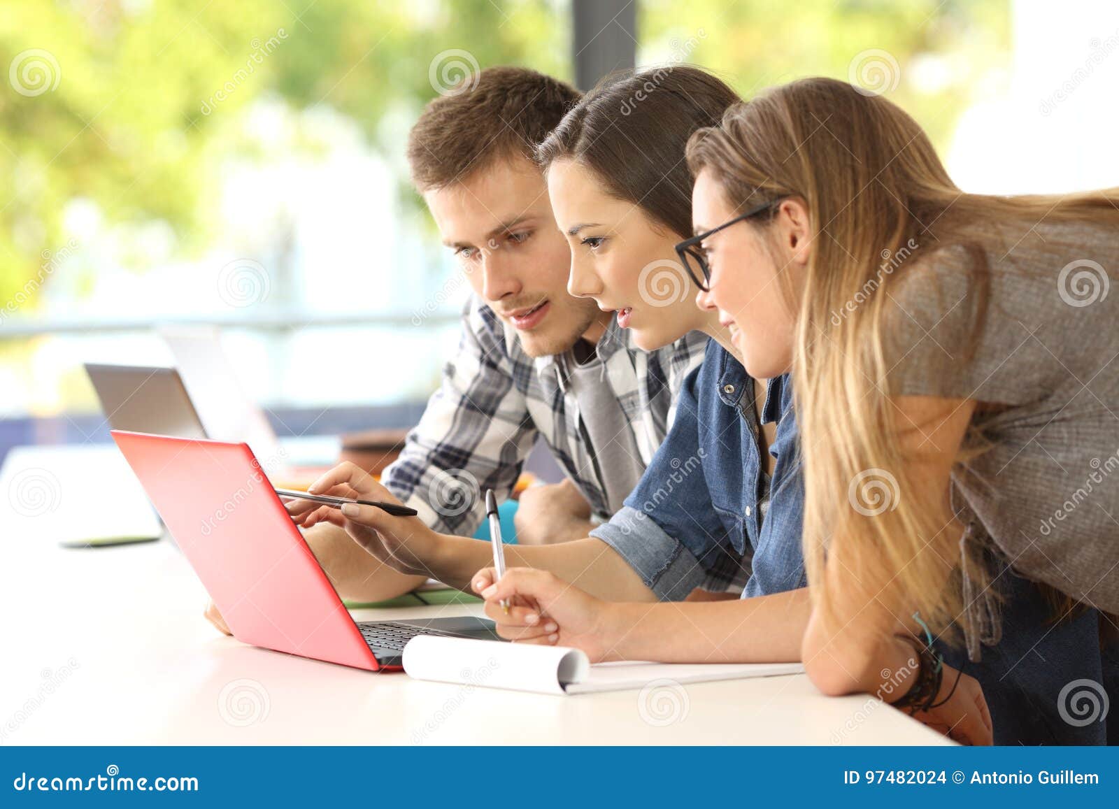 three students studying together on line