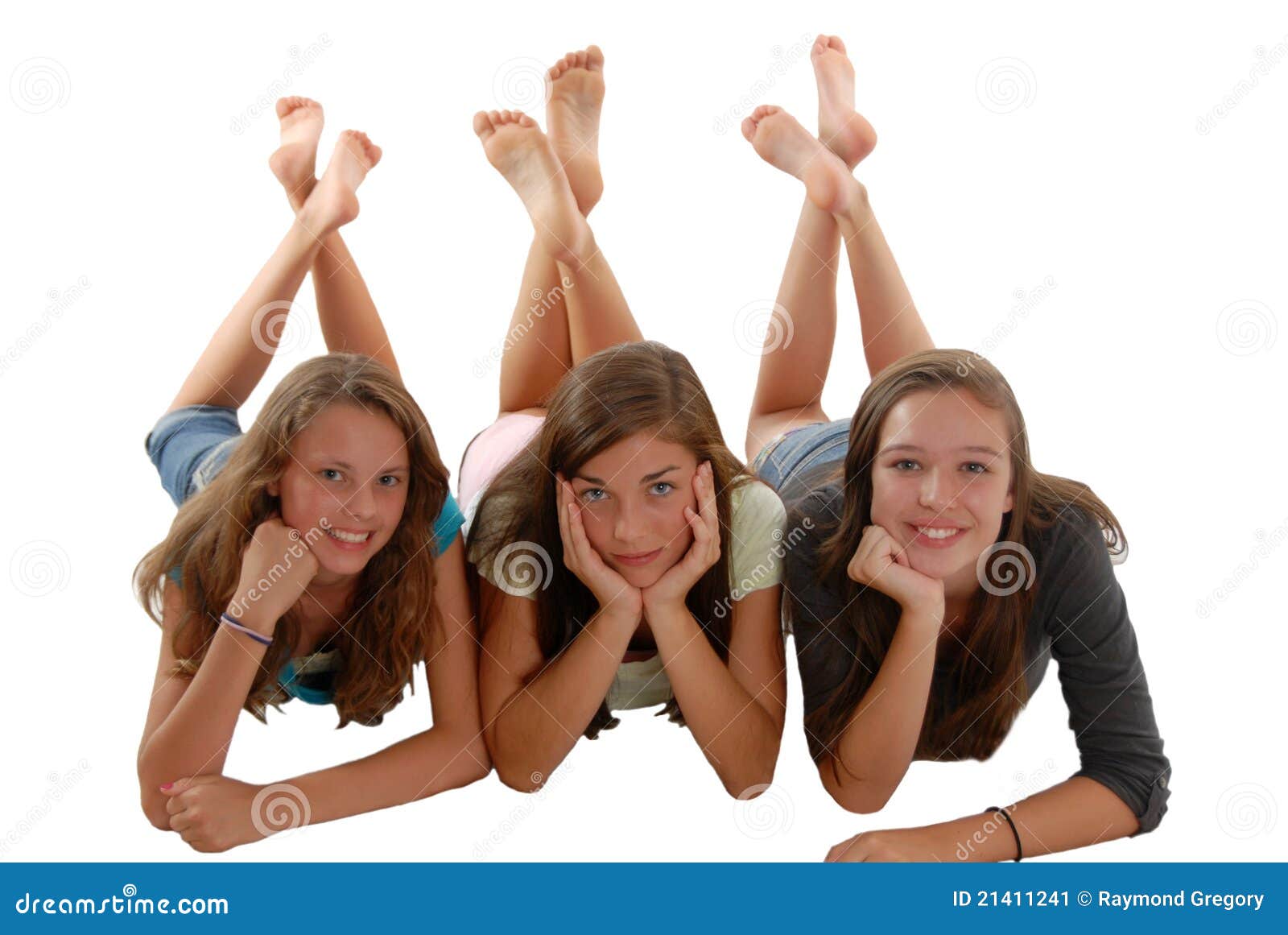 three teenage girls laying on floor chin in hand