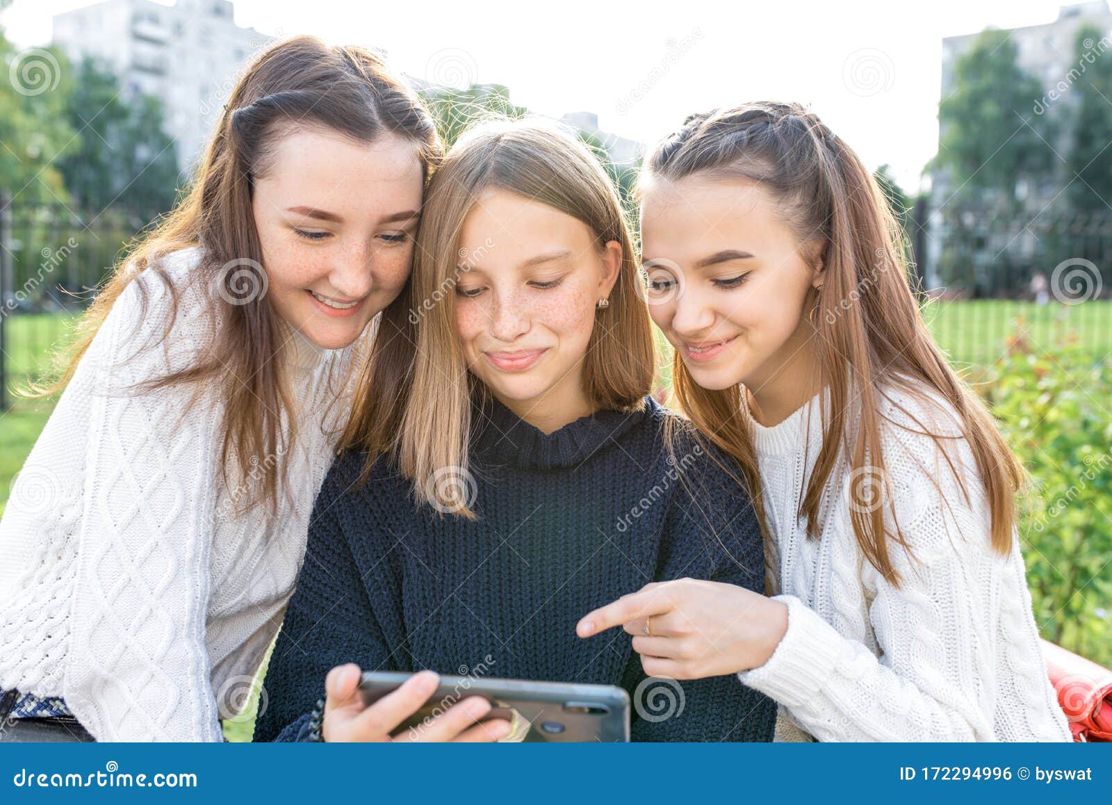 Three Teenage Girls of 12-14 Years Old, Summer City Watching Videos Phone,  Happy Smiling People Having Fun Rejoice Stock Photo - Image of happy, girl:  172294996