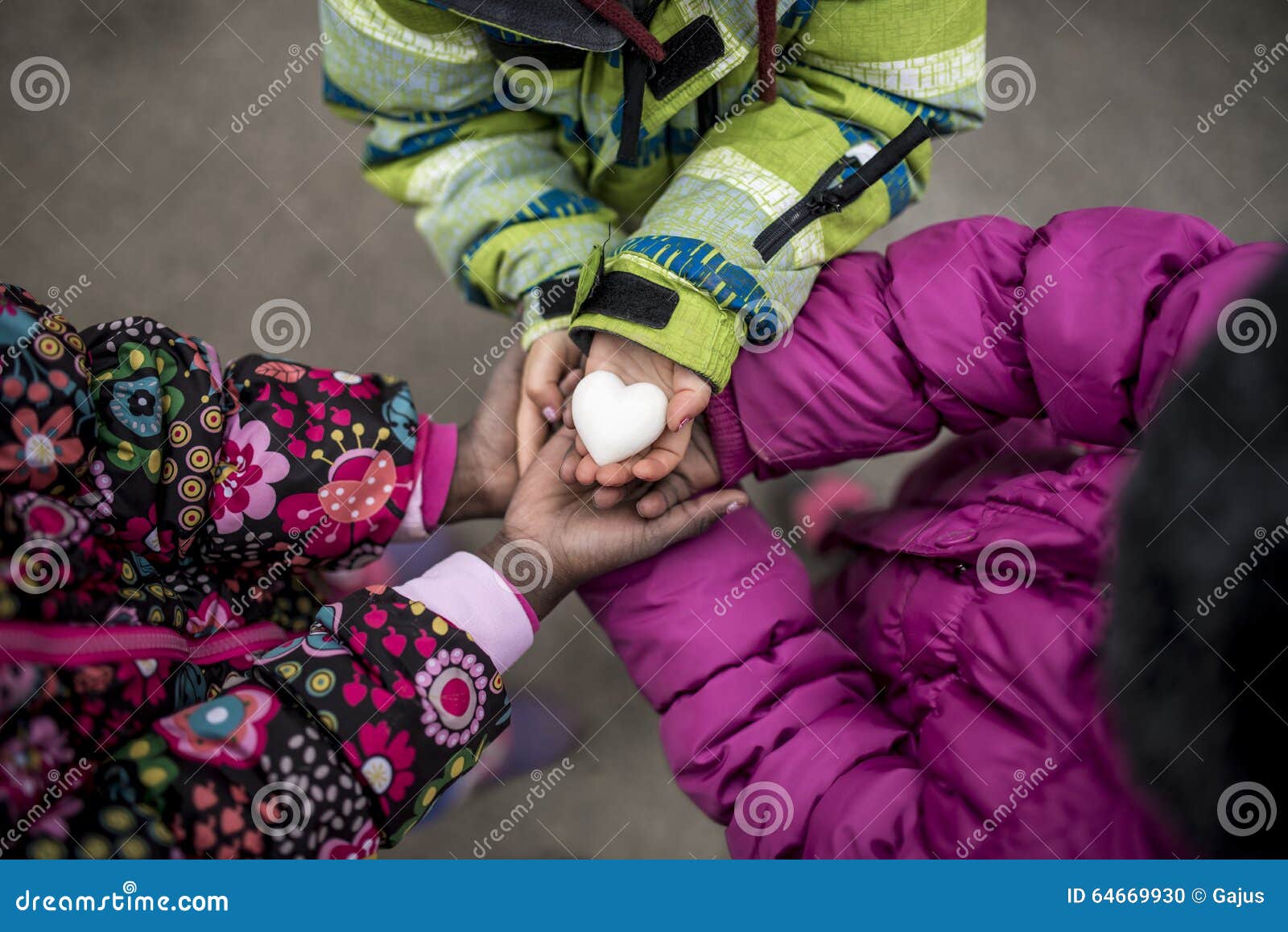 three toddler girls holding their hands joined together with the