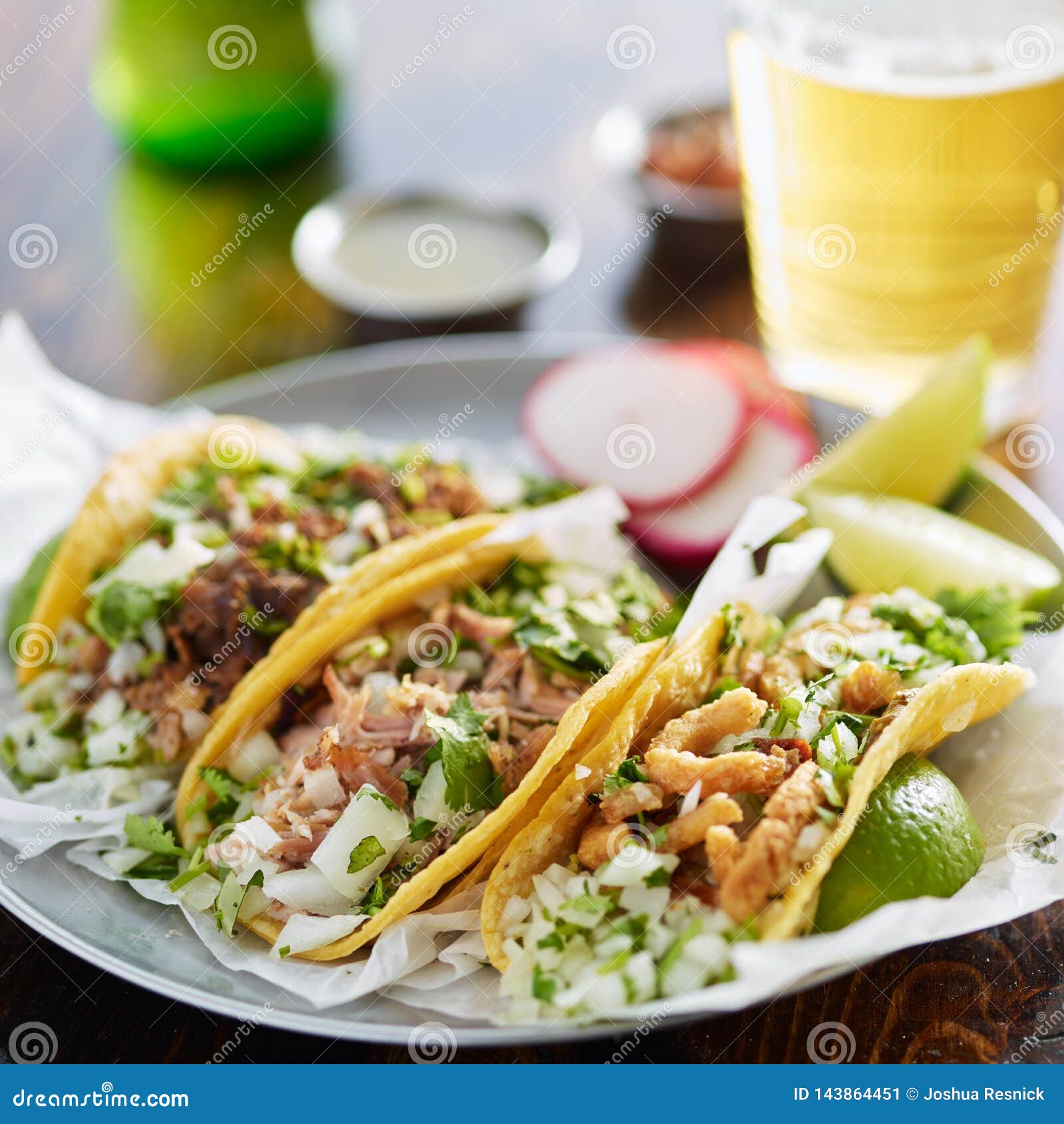 three types of mexican street tacos with barbacoa, carnitas and chicharrÃÂ³n