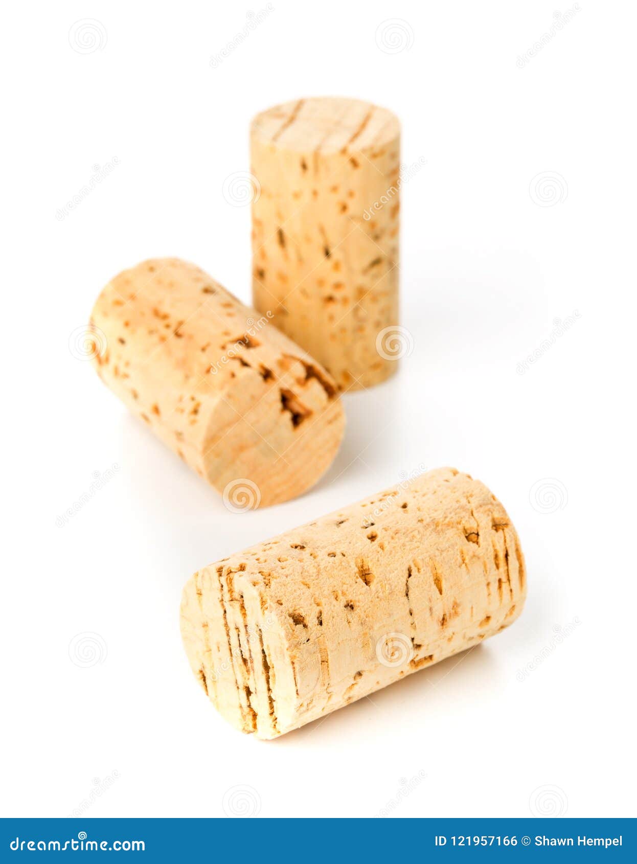 three unused, new, brown natural wine cork on white
