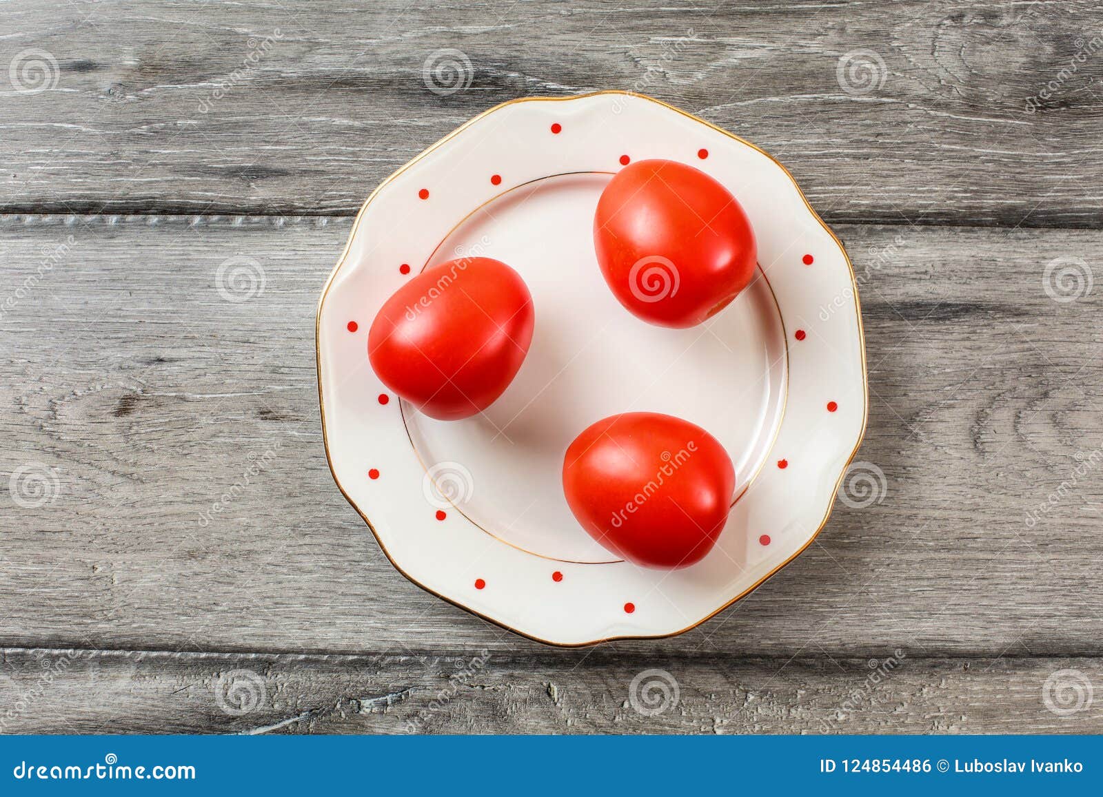 Three Stalks On A White Plate Three Whole Tomatoes On White Plate With Small Dots
