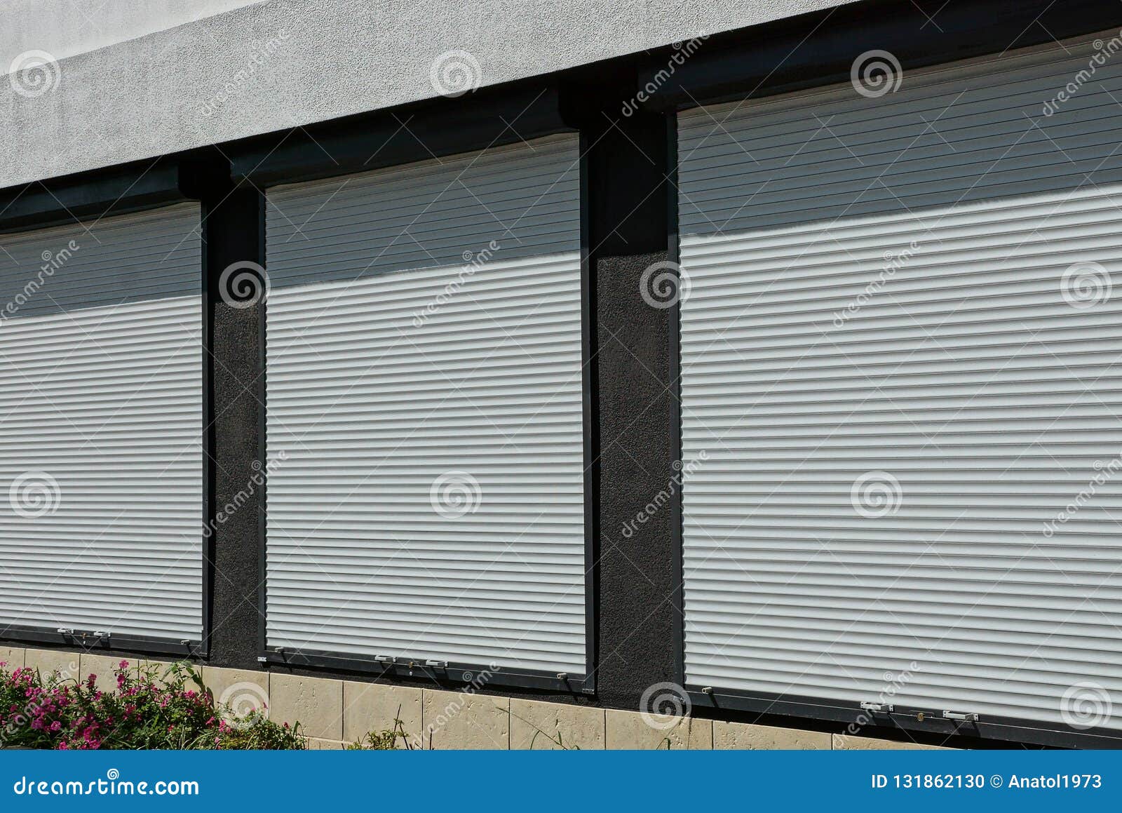 Three Windows Covered with White Plastic Shutters on the Wall of the