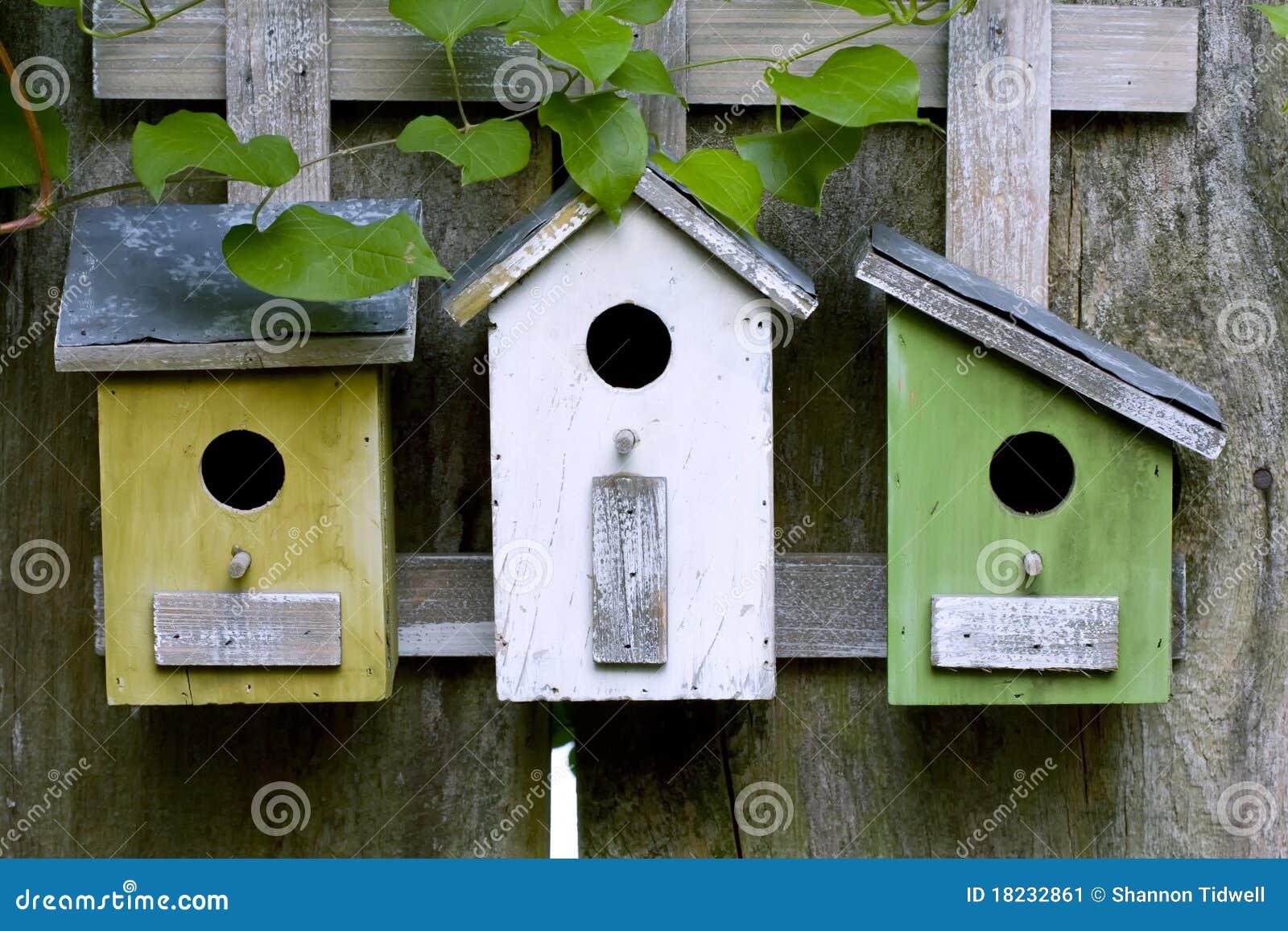 Three wooden birdhouses stock image. Image of garden 