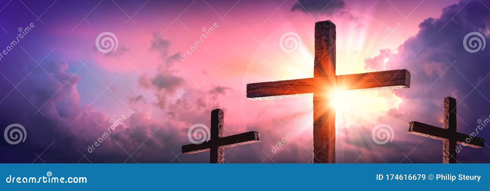 three wooden crosses with sunrise and clouds