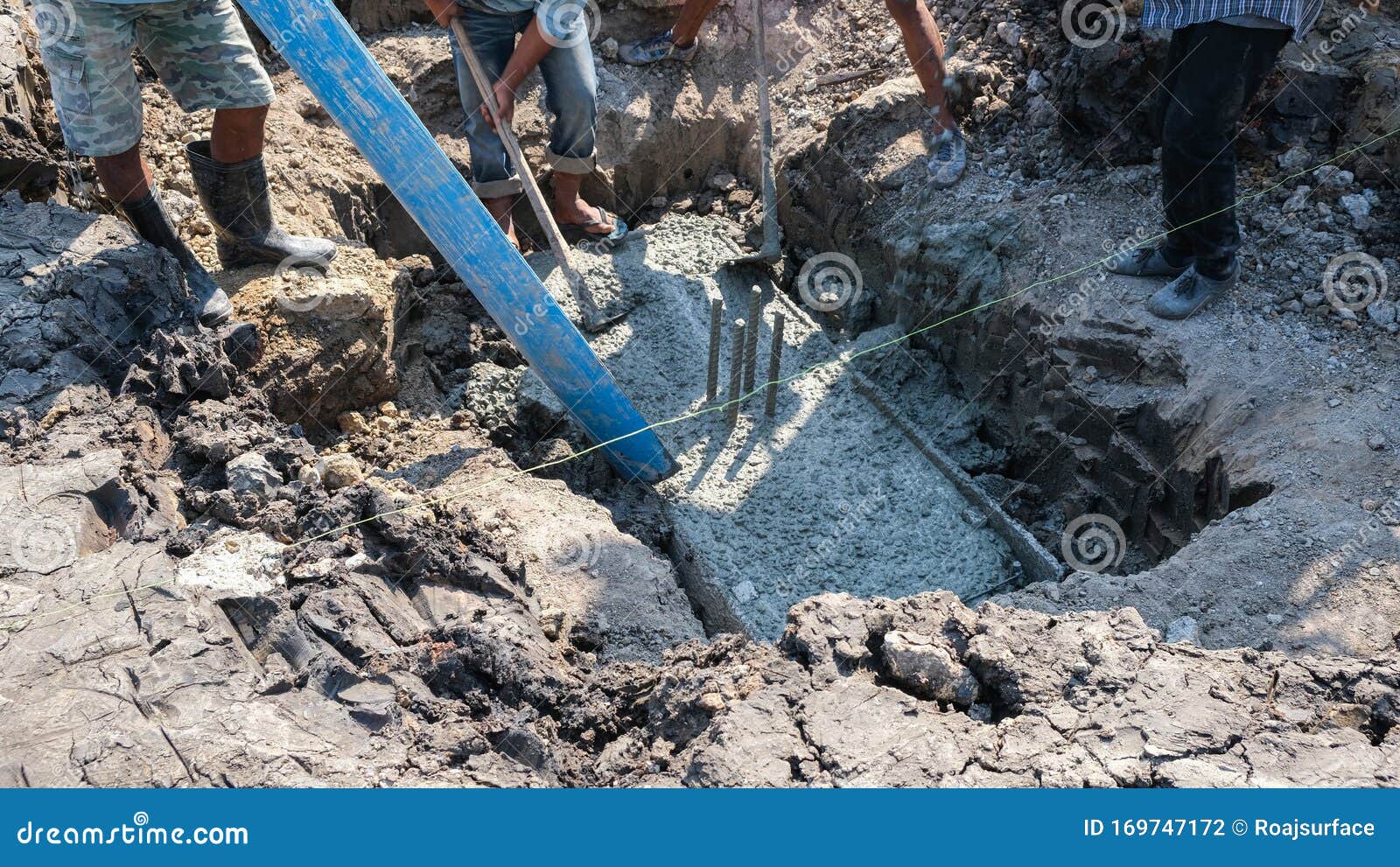Three Worker Working in House Site. Fluid Cement Filling Foundation