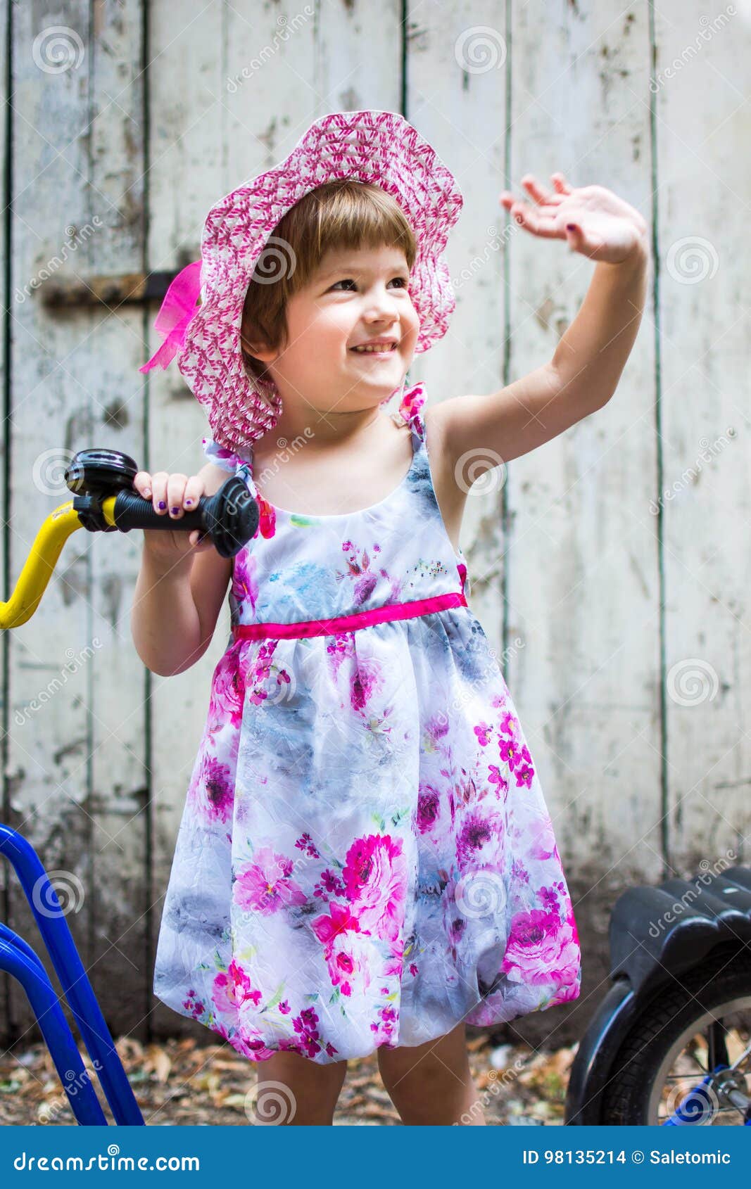 Three Years Old Girl Sending Regards with a Bicycle Stock Photo Image